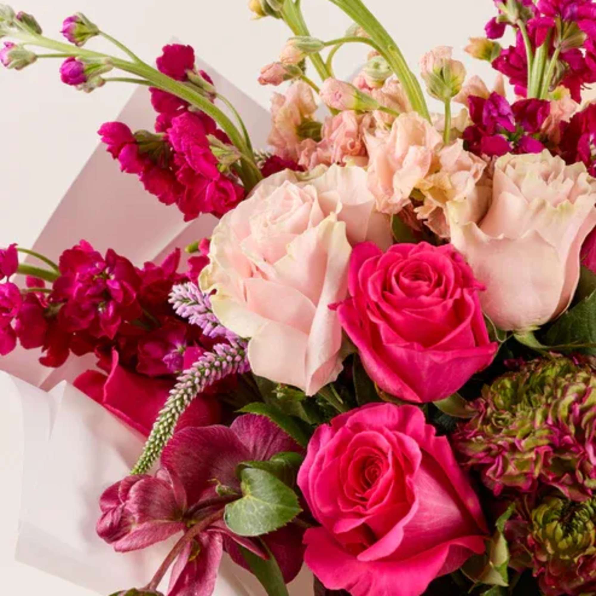 Bouquet of pink and blush roses with magenta blooms