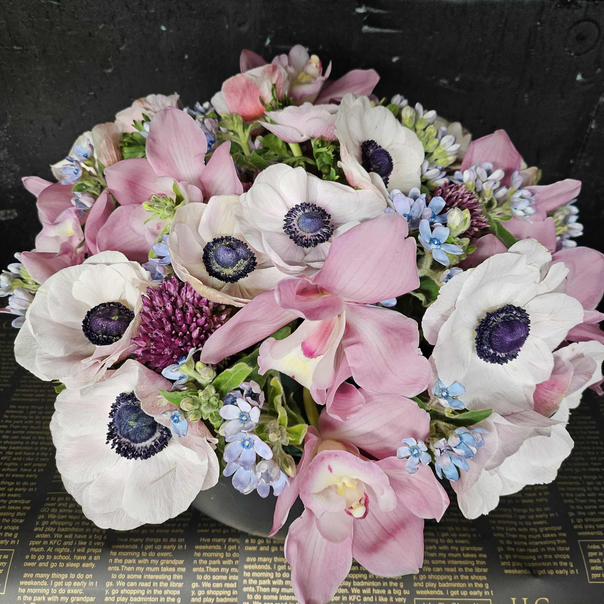 Pink and white anemone bouquet with small blue flowers