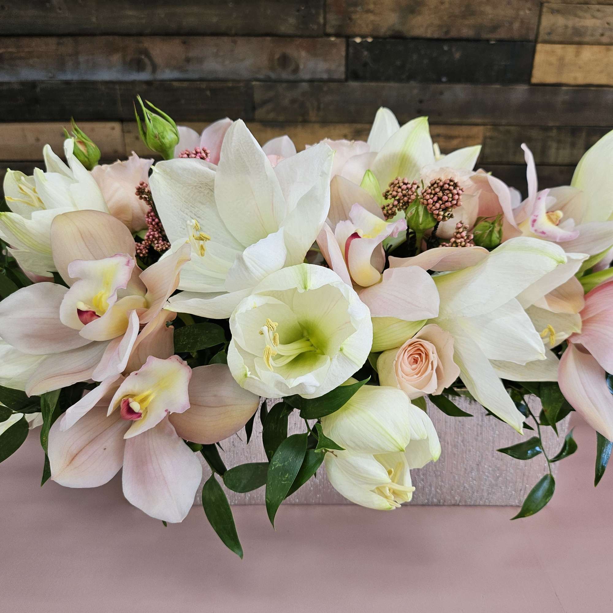 Pastel bouquet of white and blush flowers with green foliage