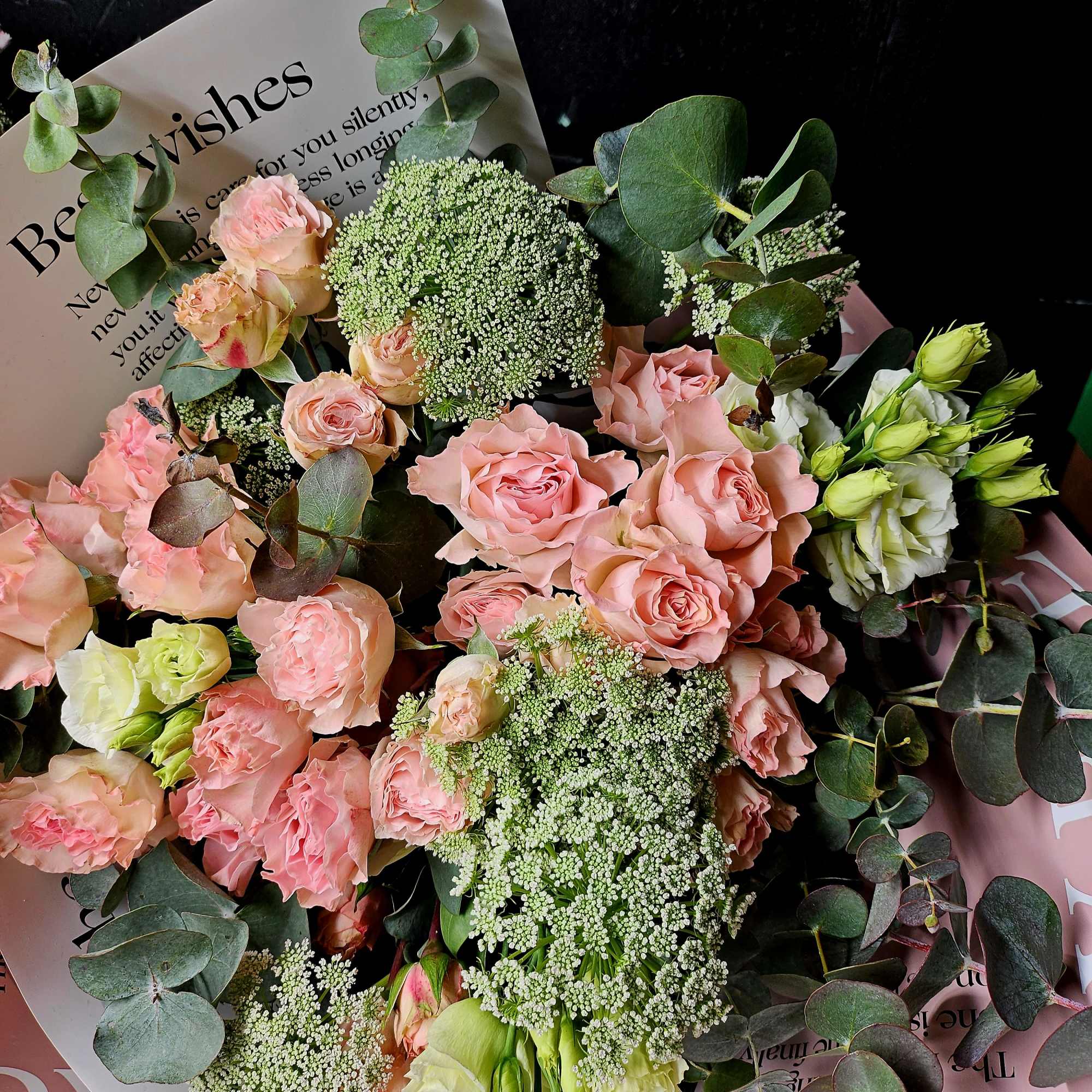 Bouquet of pink roses with white filler flowers and eucalyptus