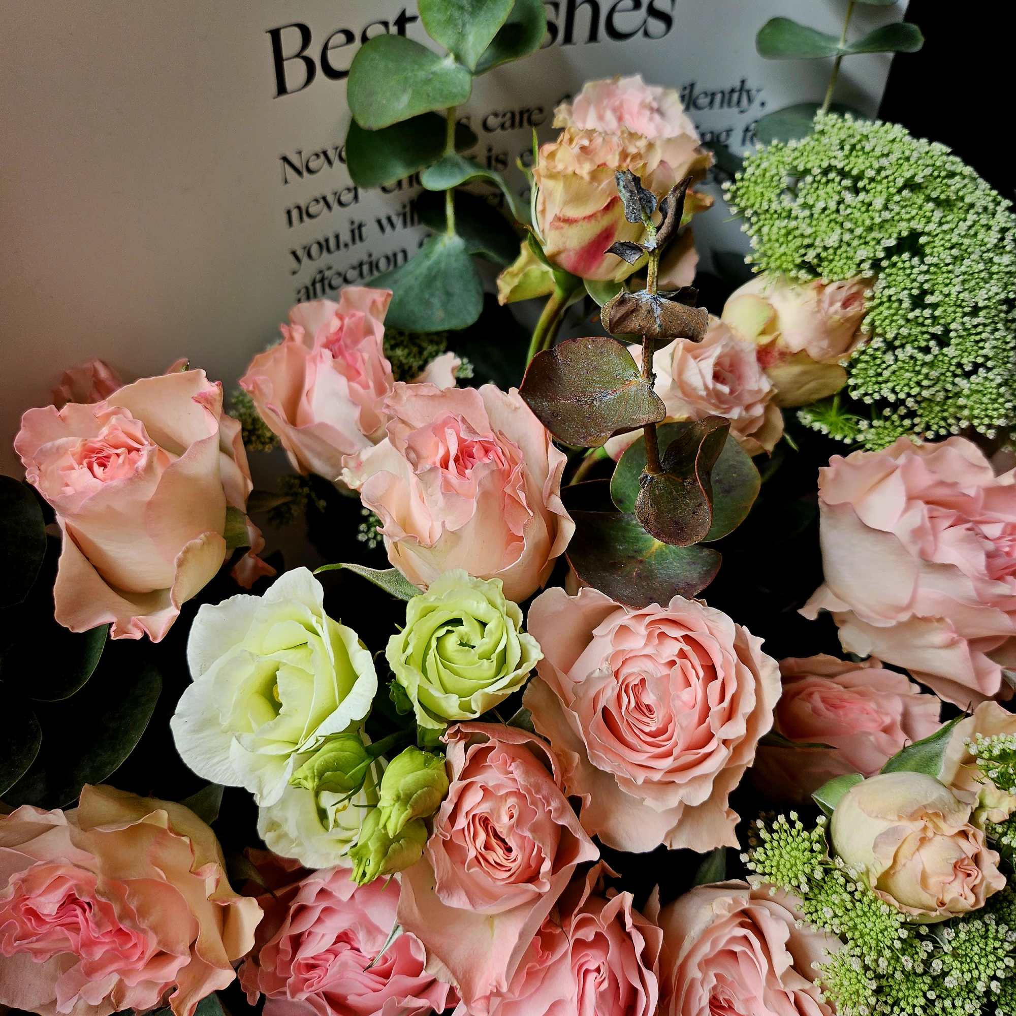 Bouquet of pink and peach roses with eucalyptus and green filler