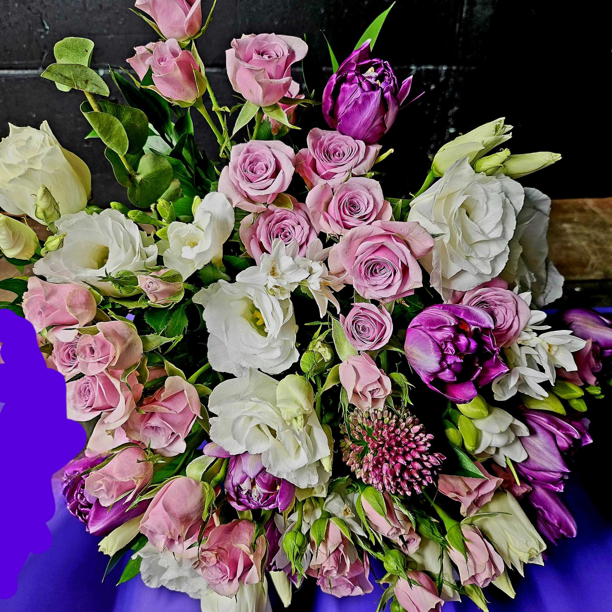 Bouquet of pink and white roses with purple tulips and white lisianthus