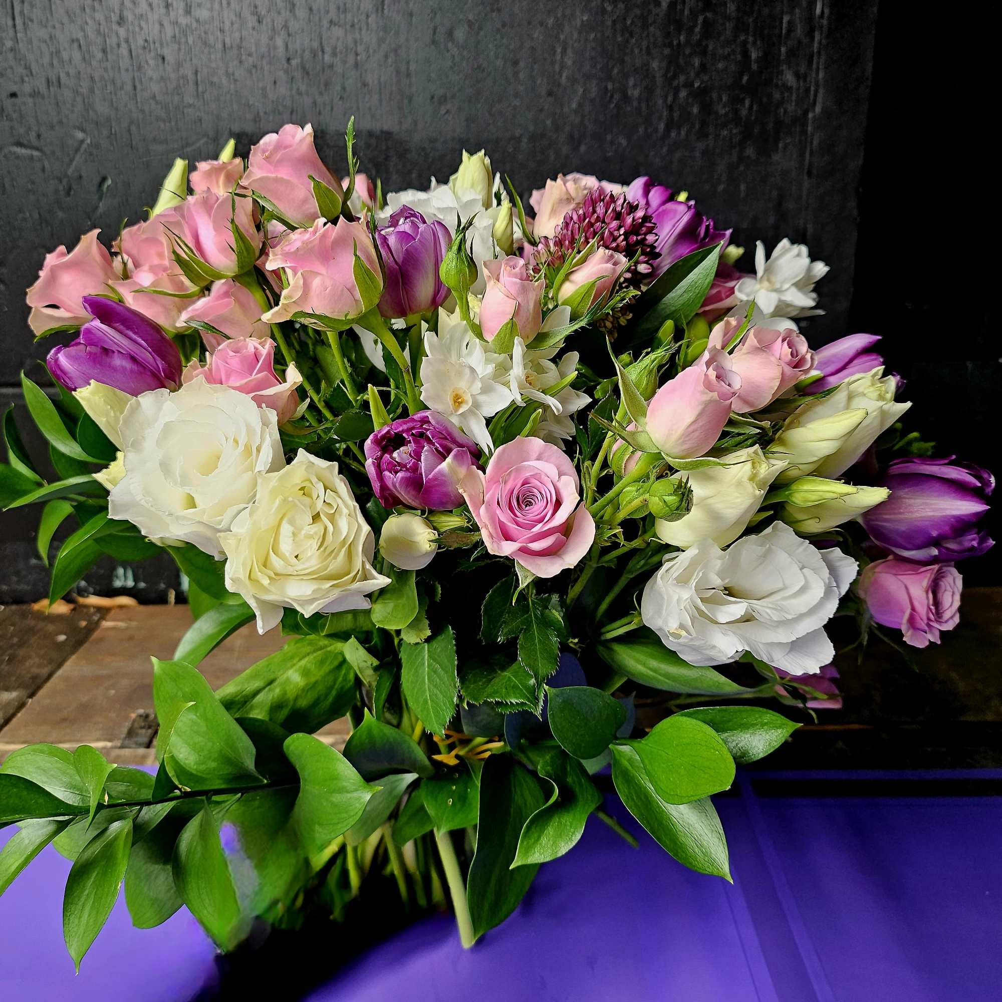 Bouquet of pink, white, and purple flowers with greenery
