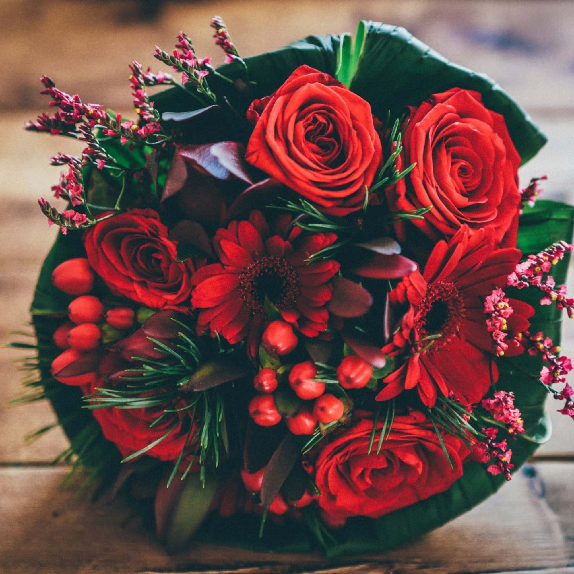 Red rose bouquet with red daisies and small pink filler flowers