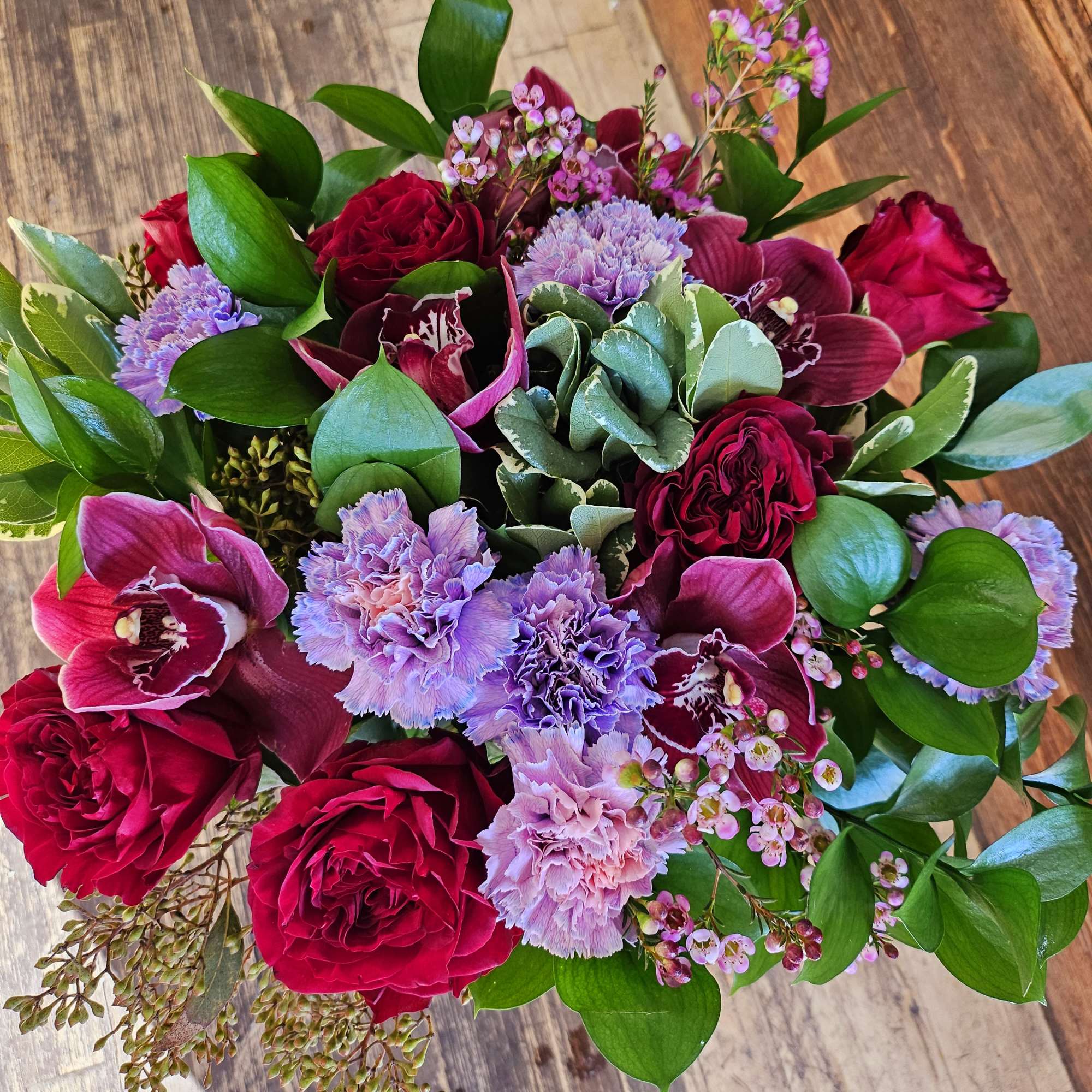 Bouquet of red roses, purple orchids, and pink carnations, photo 2 of 3