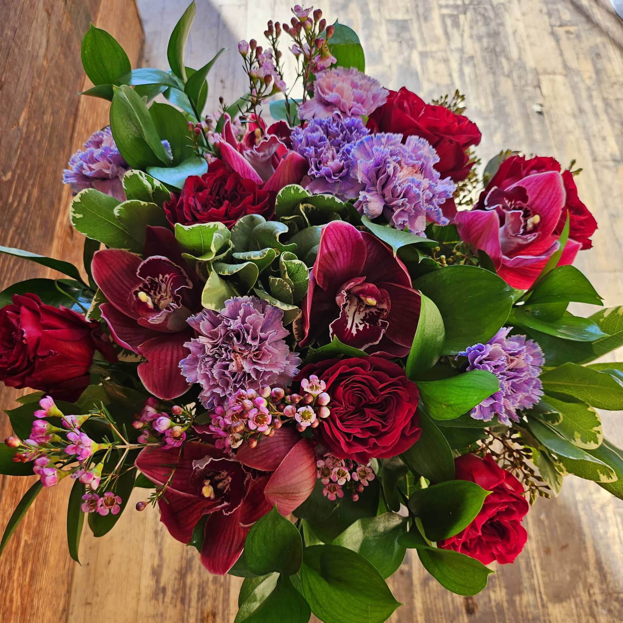 Bouquet of red roses, purple orchids, and pink carnations, photo 3 of 3