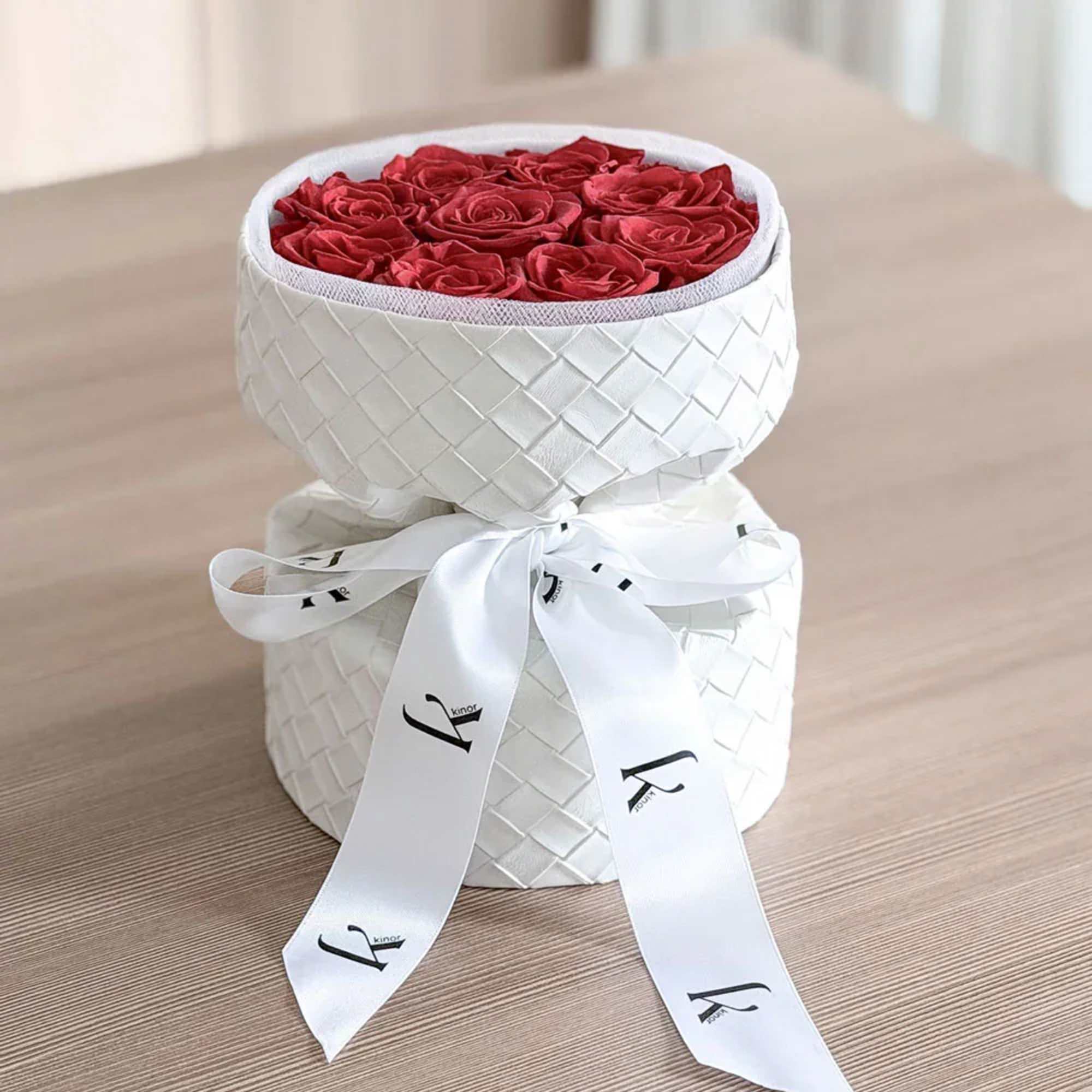 Red roses arranged in a white woven hatbox with a ribbon bow, photo 2 of 3