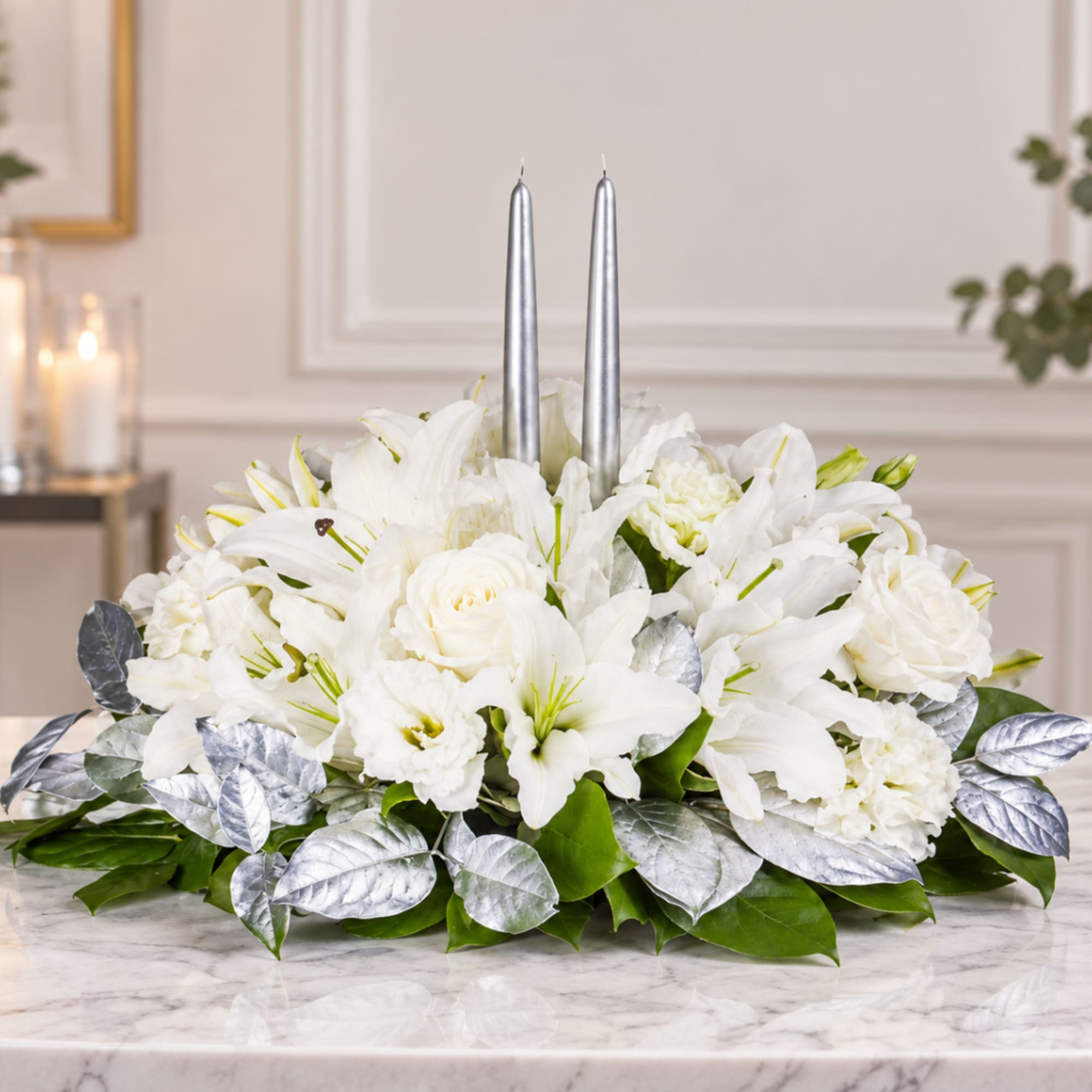 White floral centerpiece with two silver taper candles, photo 2 of 3
