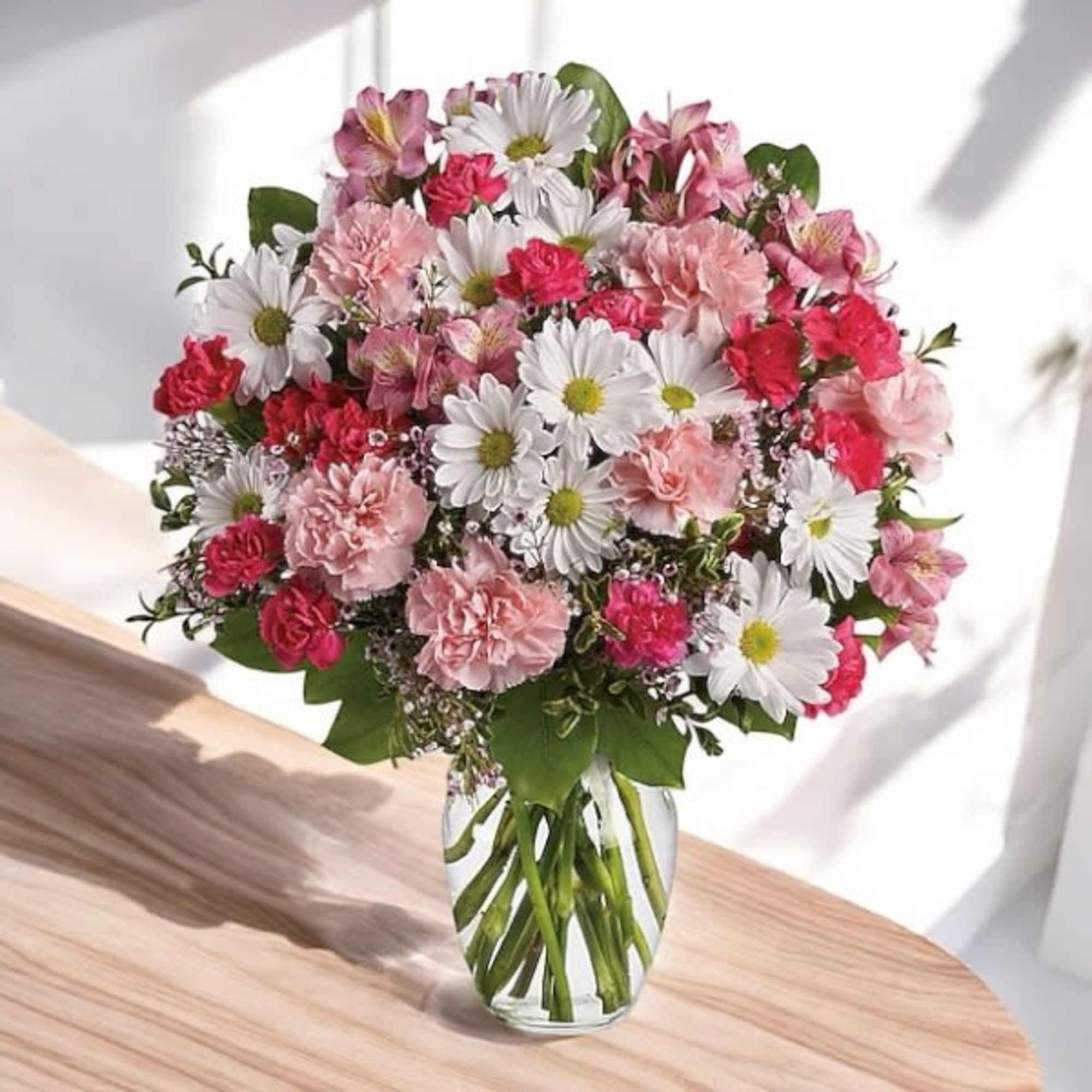 Pink and white mixed bouquet in a clear glass vase
