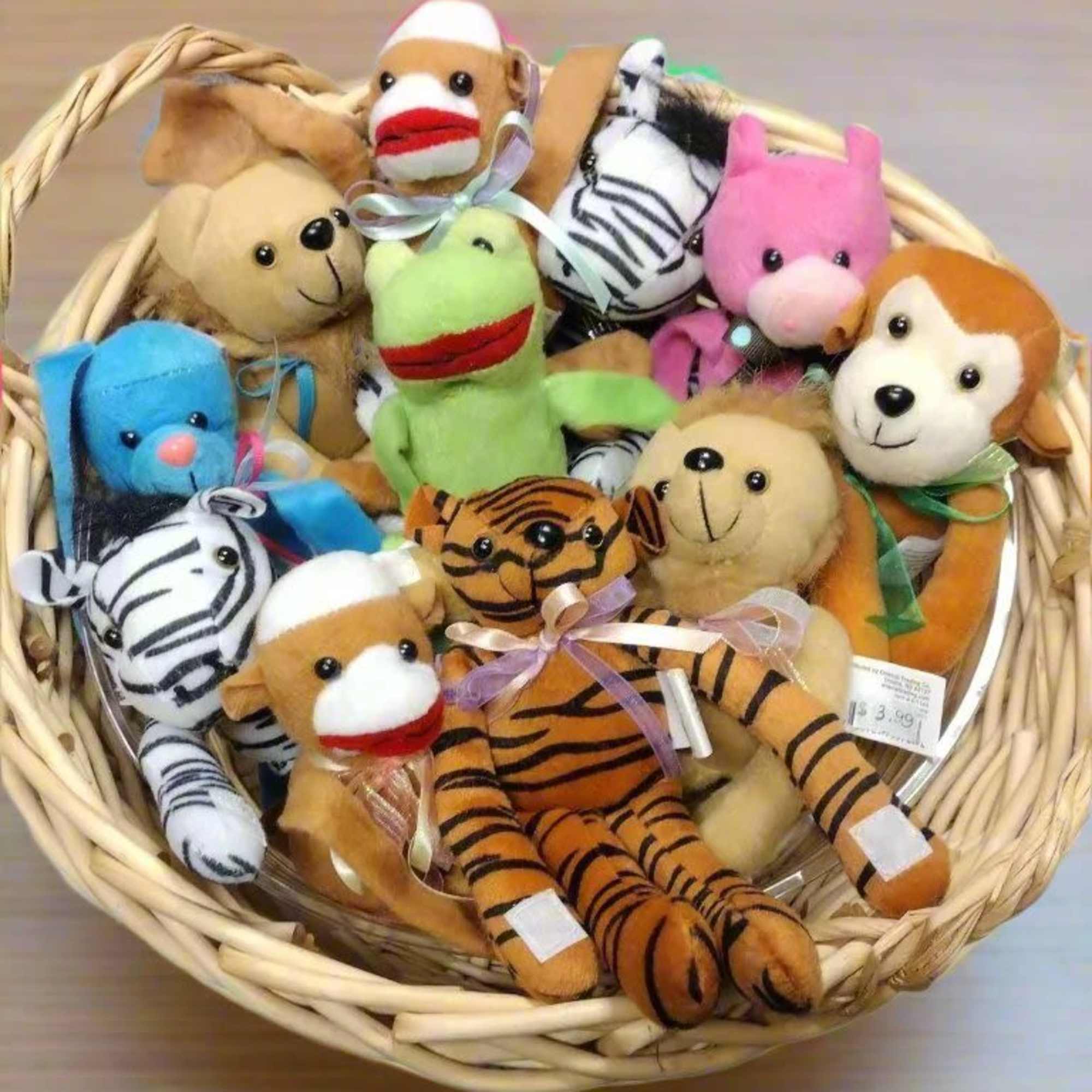 Basket of small animal plush toys in assorted colors