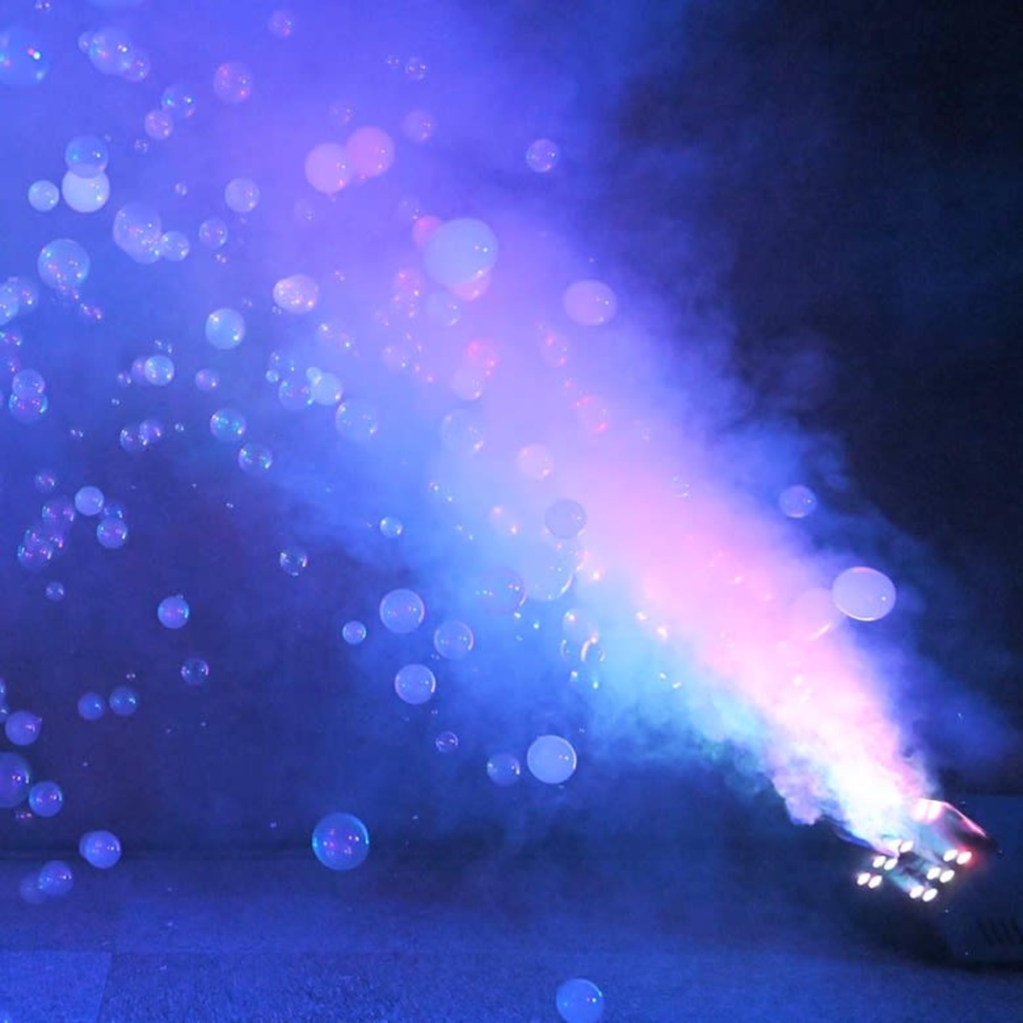 Blue and pink stage fog with floating bubbles