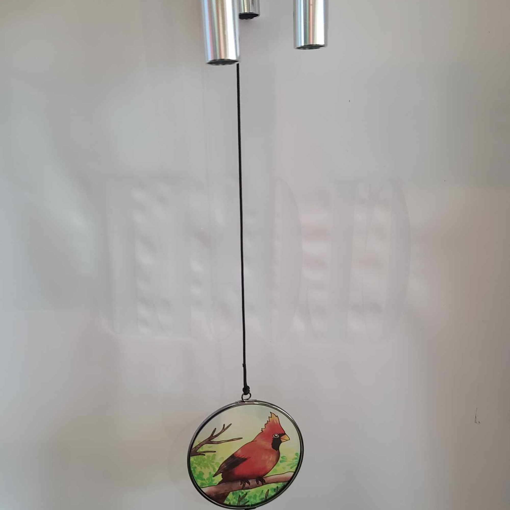 Metal wind chime with a round cardinal ornament