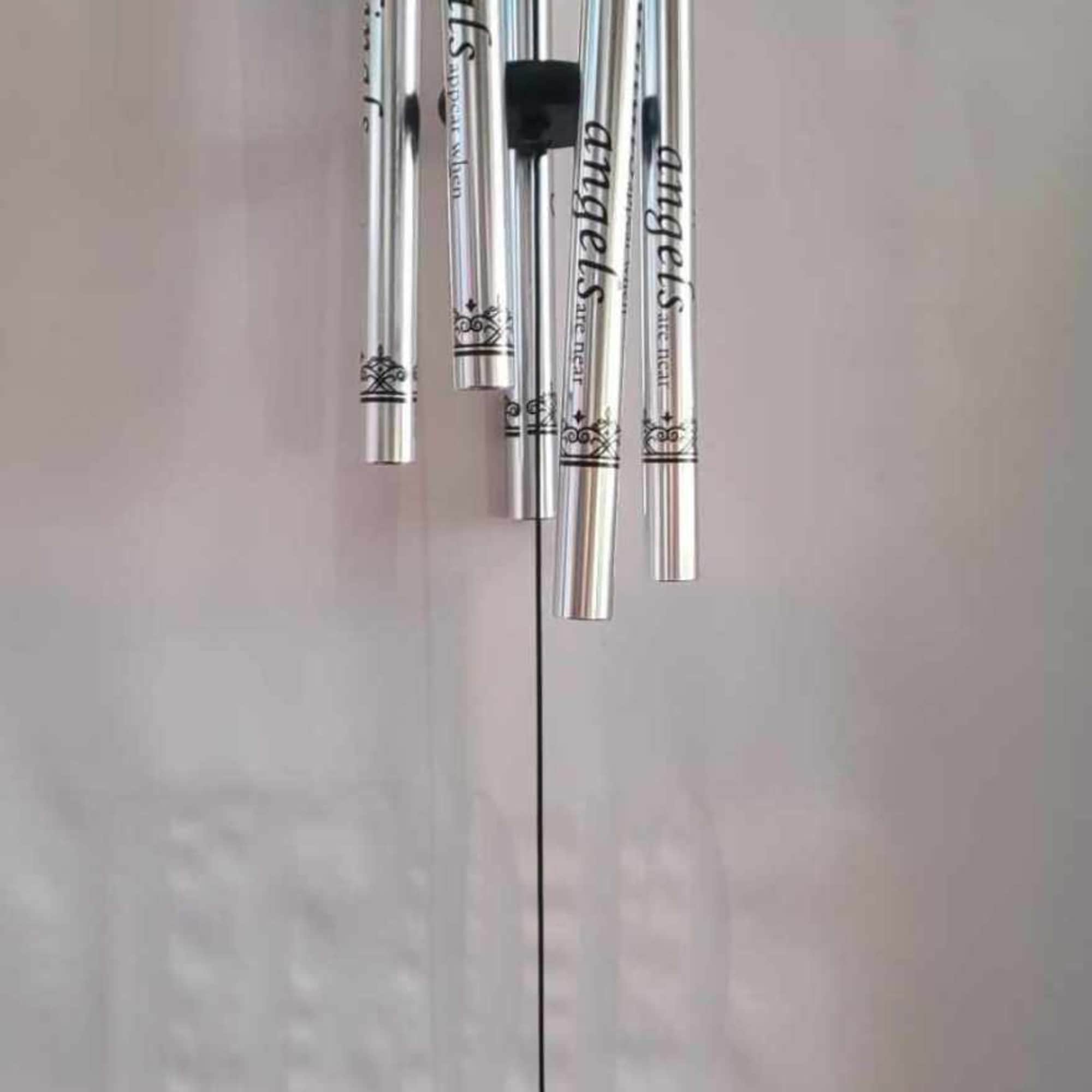 Silver wind chime with a cardinal medallion hanging below.