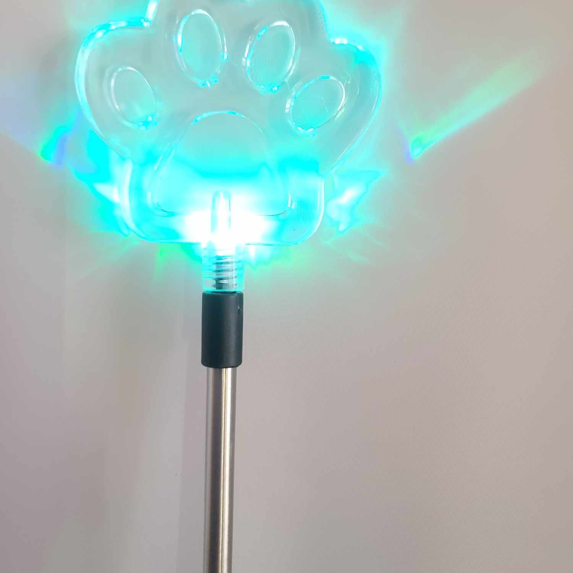Glowing blue paw-shaped light on a metal pole