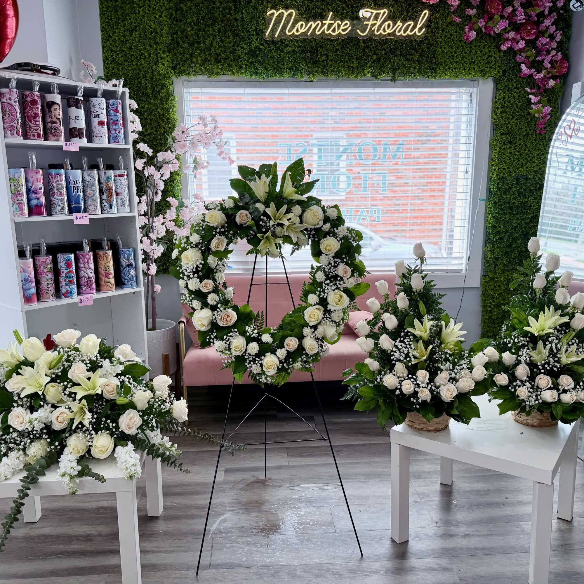 White rose and lily sympathy set with heart wreath on stand and coordinating sprays on white tables