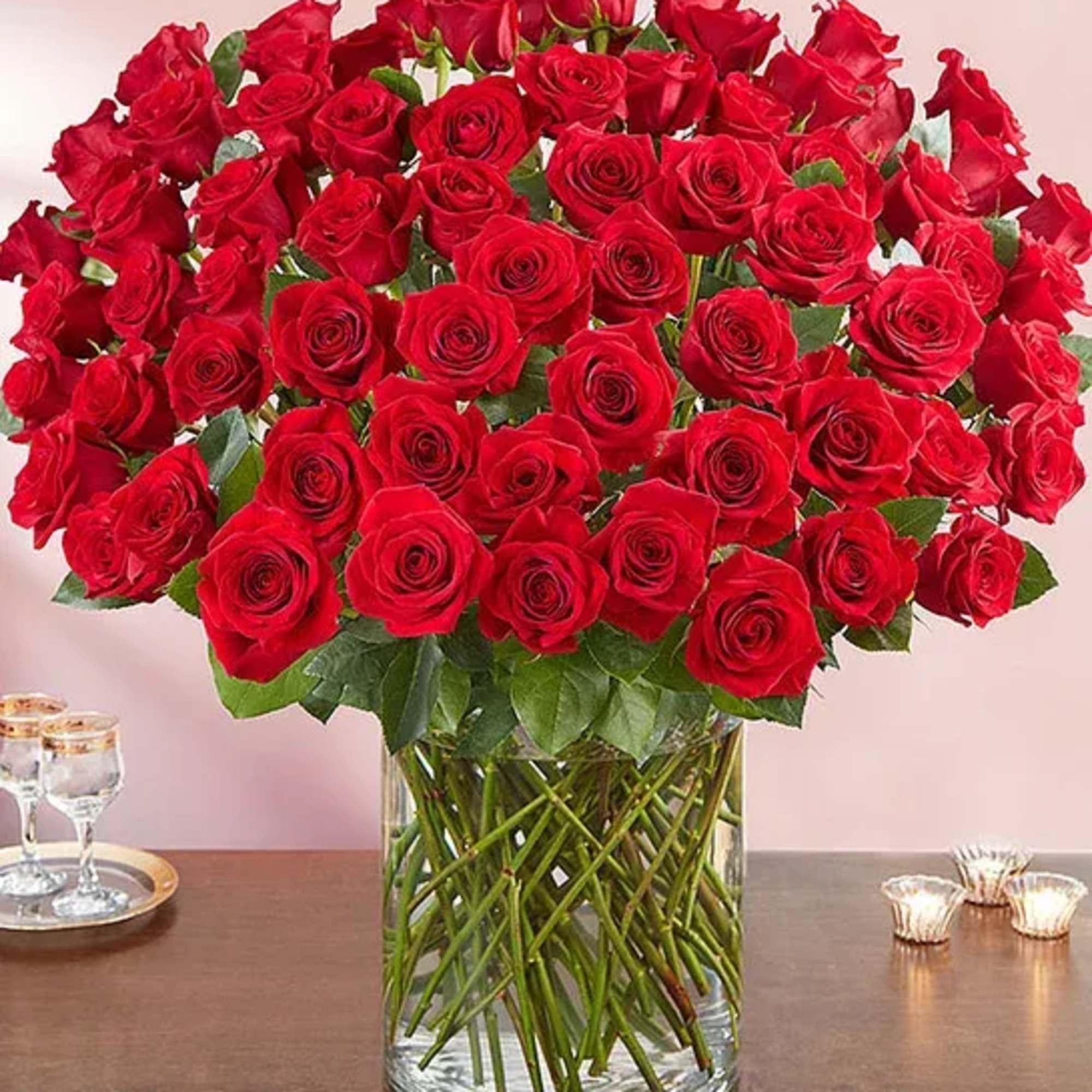 Large bouquet of red roses in a clear glass vase