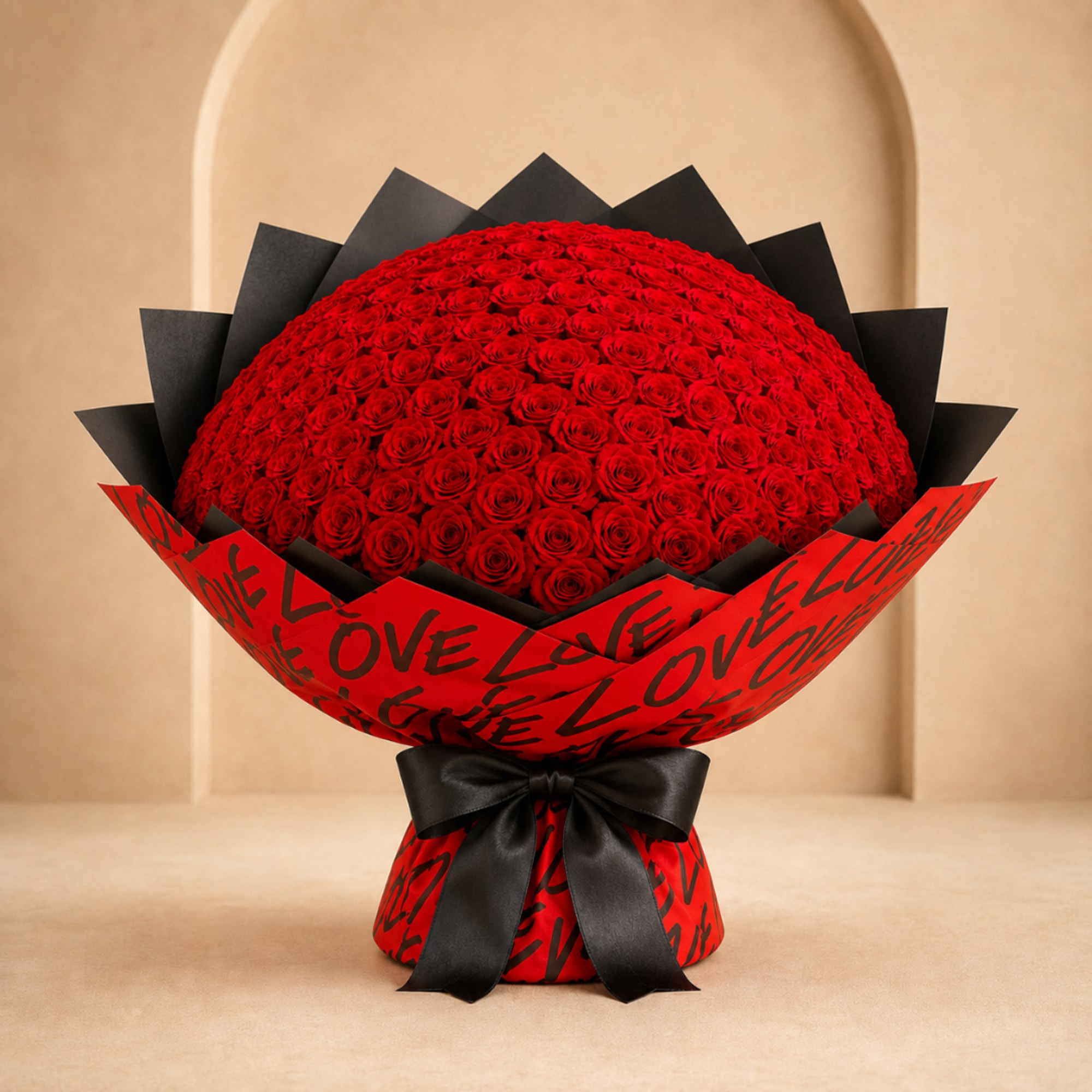 Large bouquet of red roses wrapped in red and black paper with a black ribbon