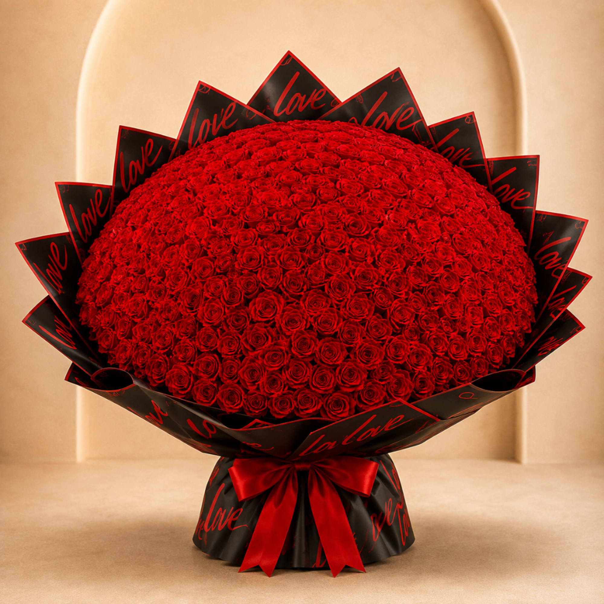Large bouquet of red roses wrapped in black paper with a red ribbon