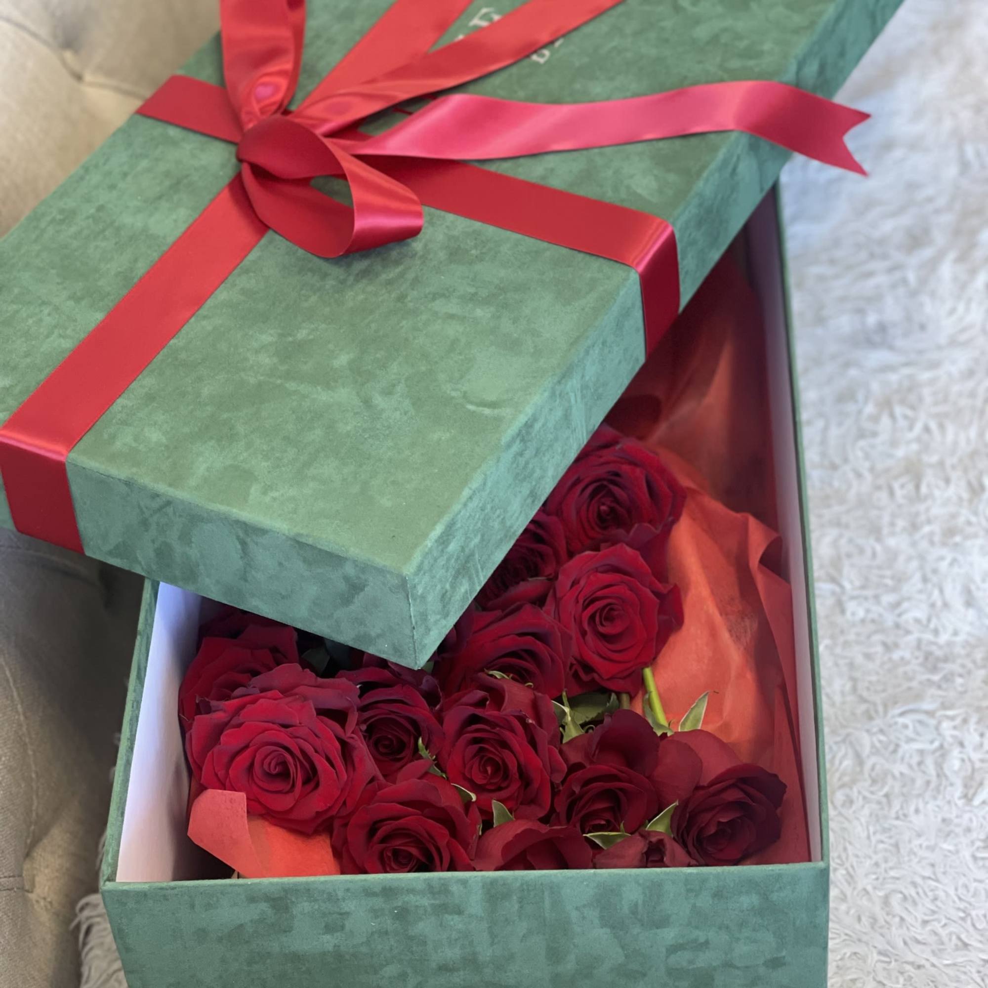 Box of red roses with a red ribbon bow