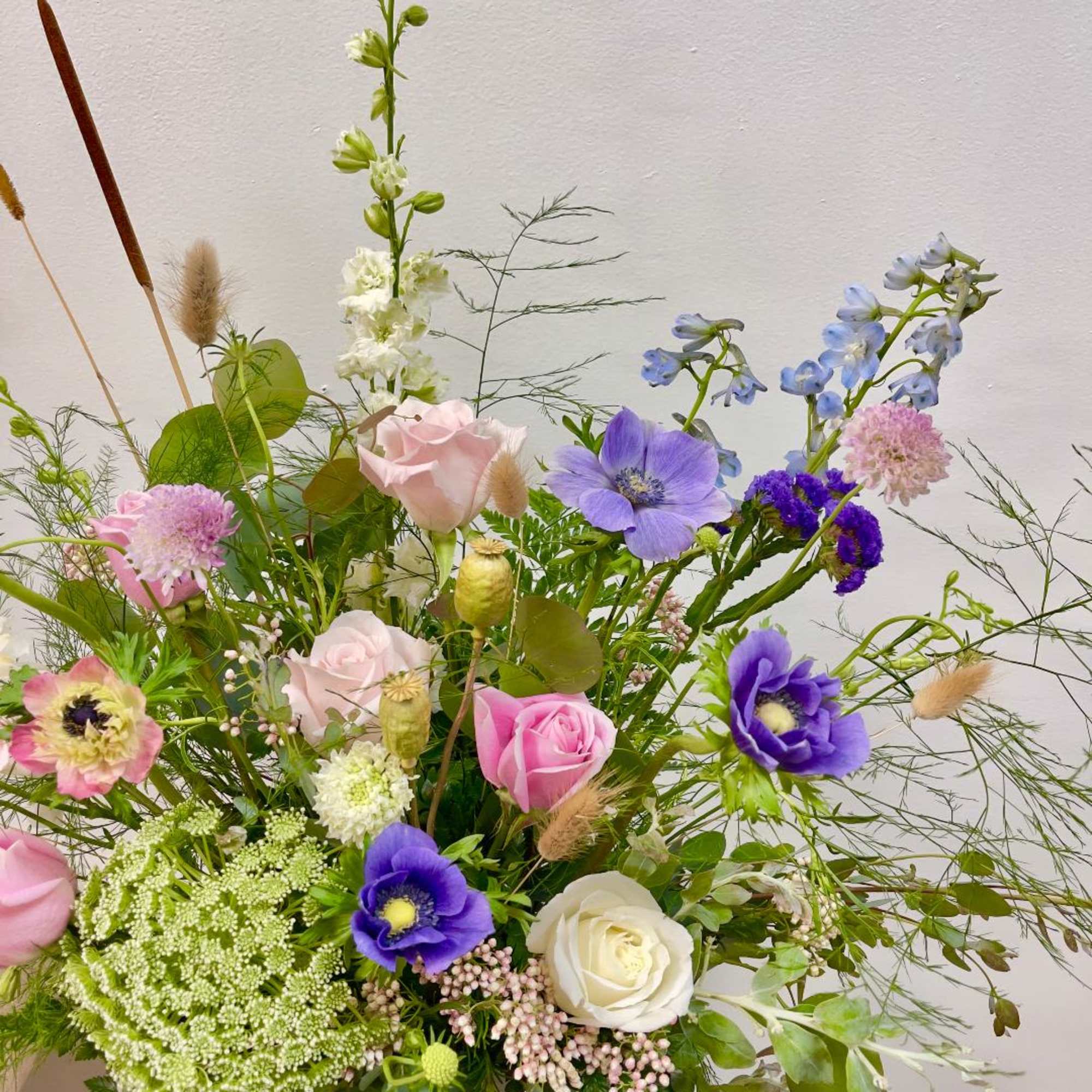 Mixed bouquet with pink, purple, white, and blue flowers