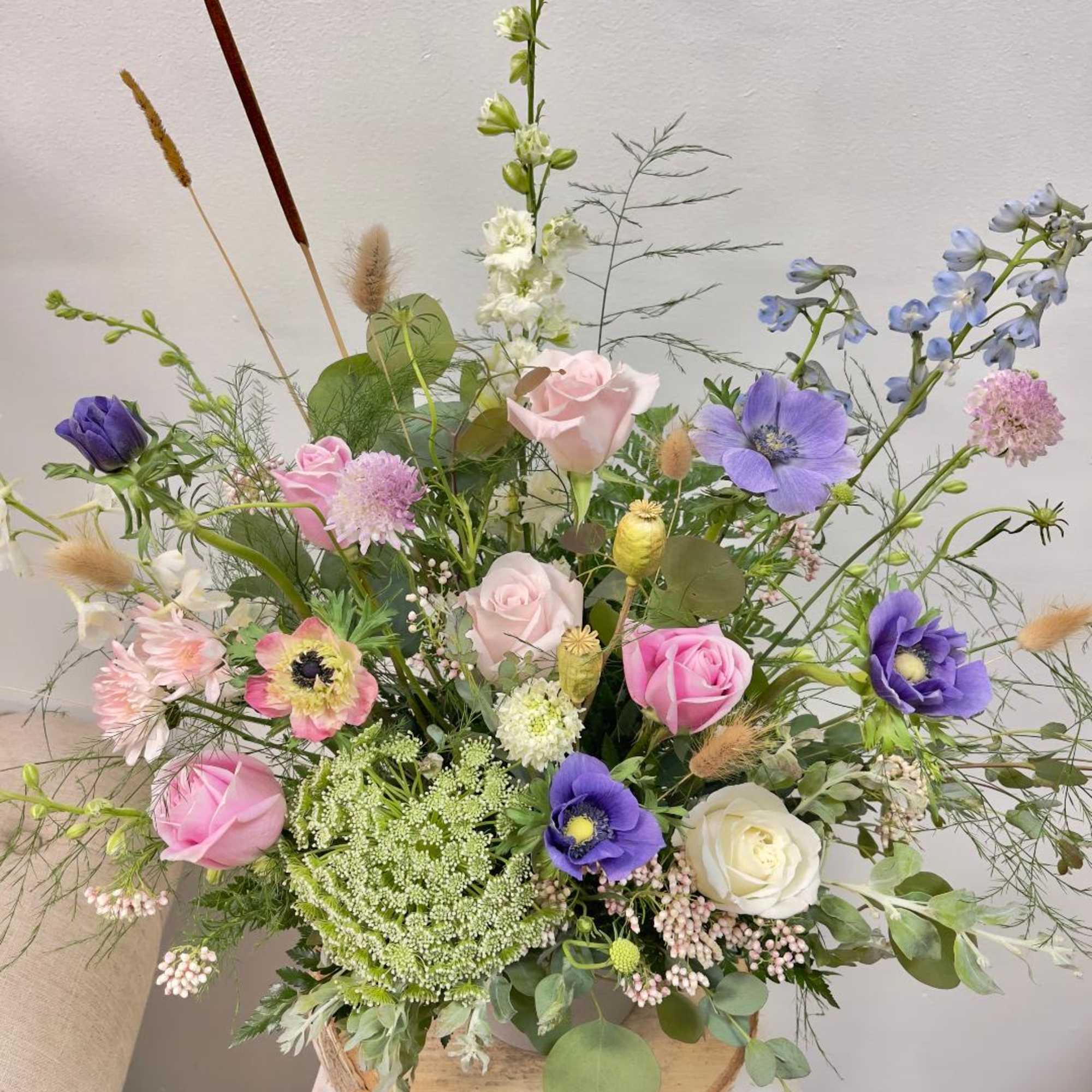 Mixed bouquet of pink, purple, white, and blue flowers in a vase