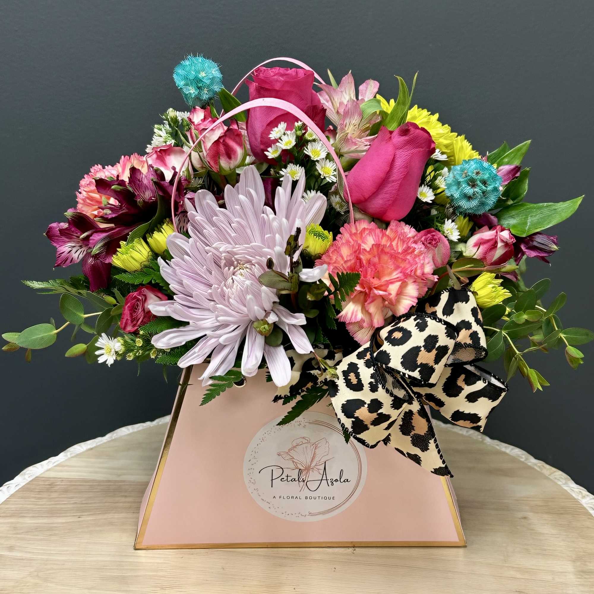 Mixed bouquet in a pink gift box with a leopard-print bow