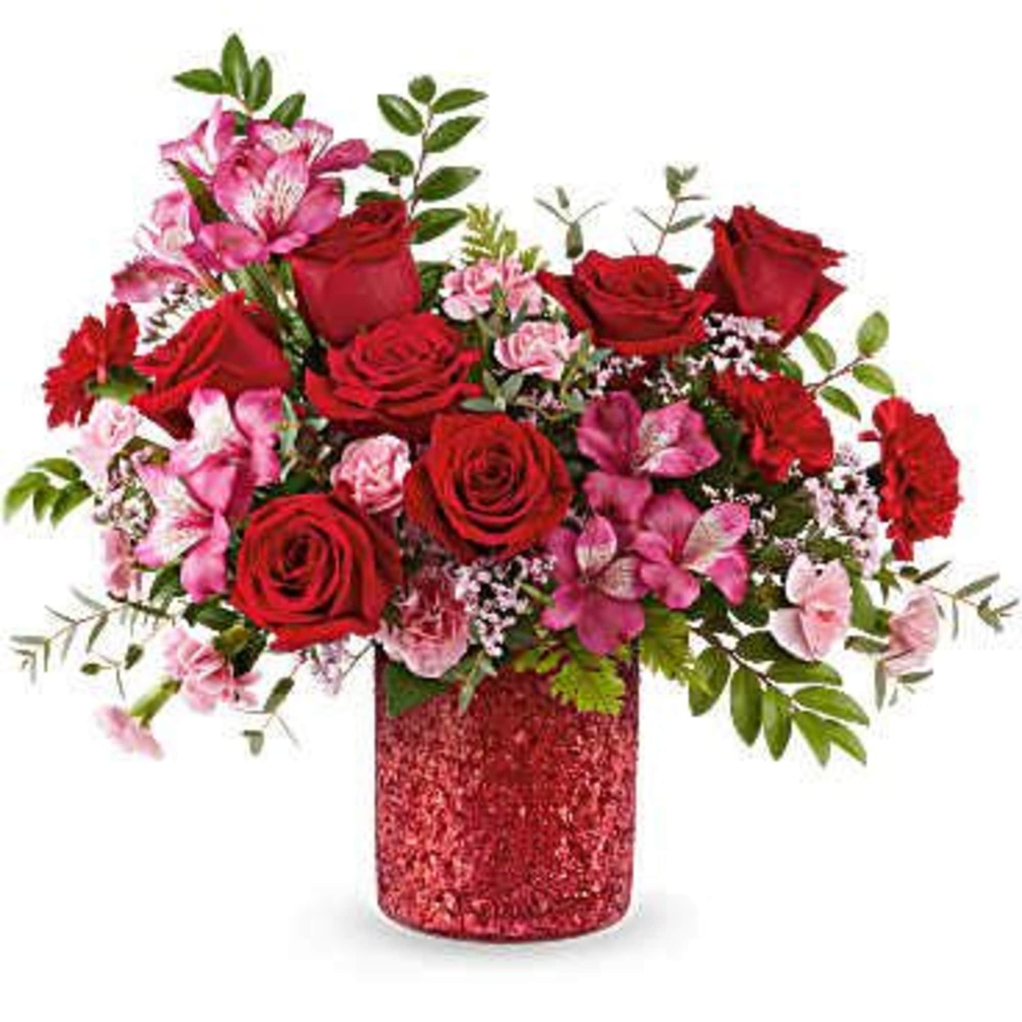 Red roses and pink flowers in a glittery red vase