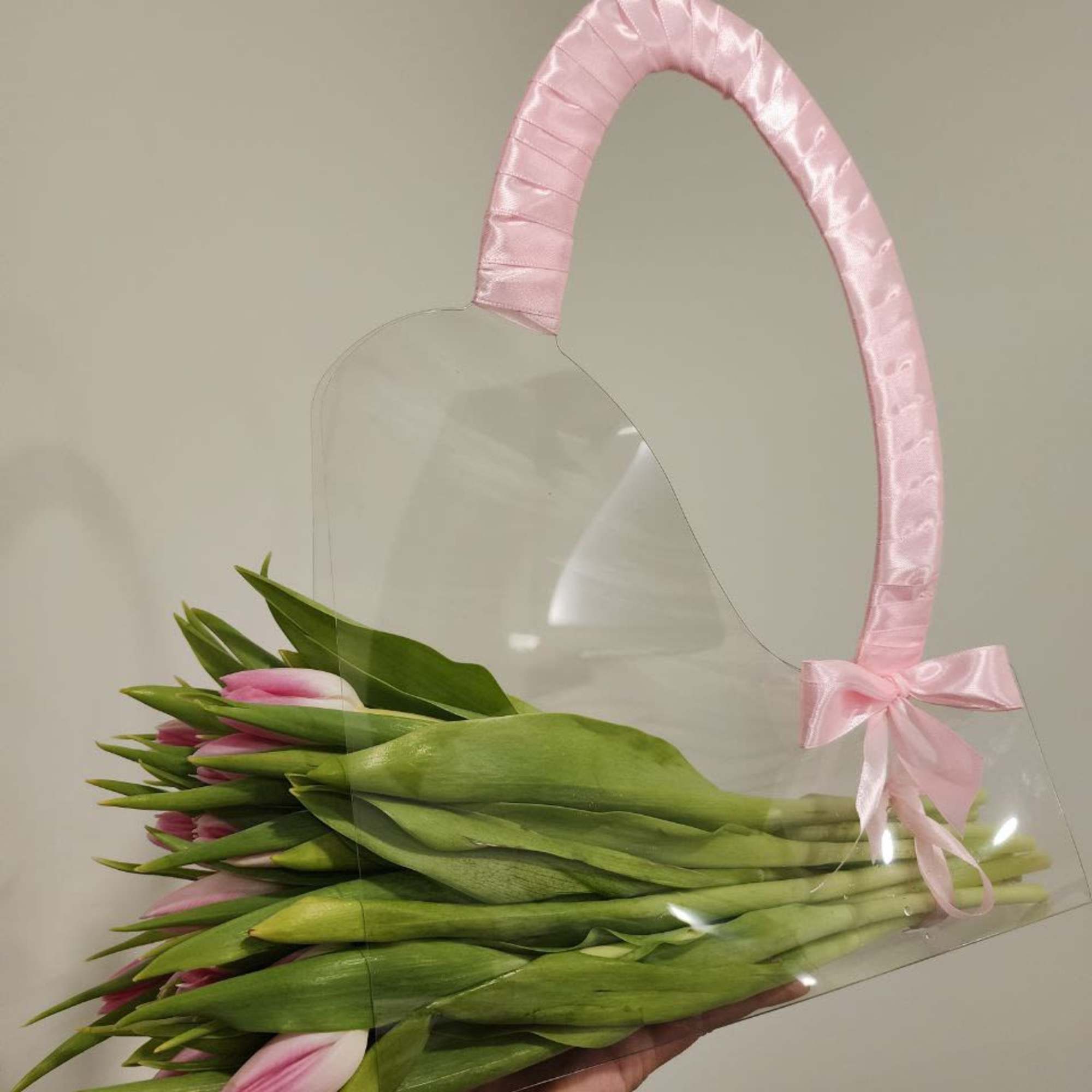Pink tulips in a clear gift bag with a pink ribbon handle