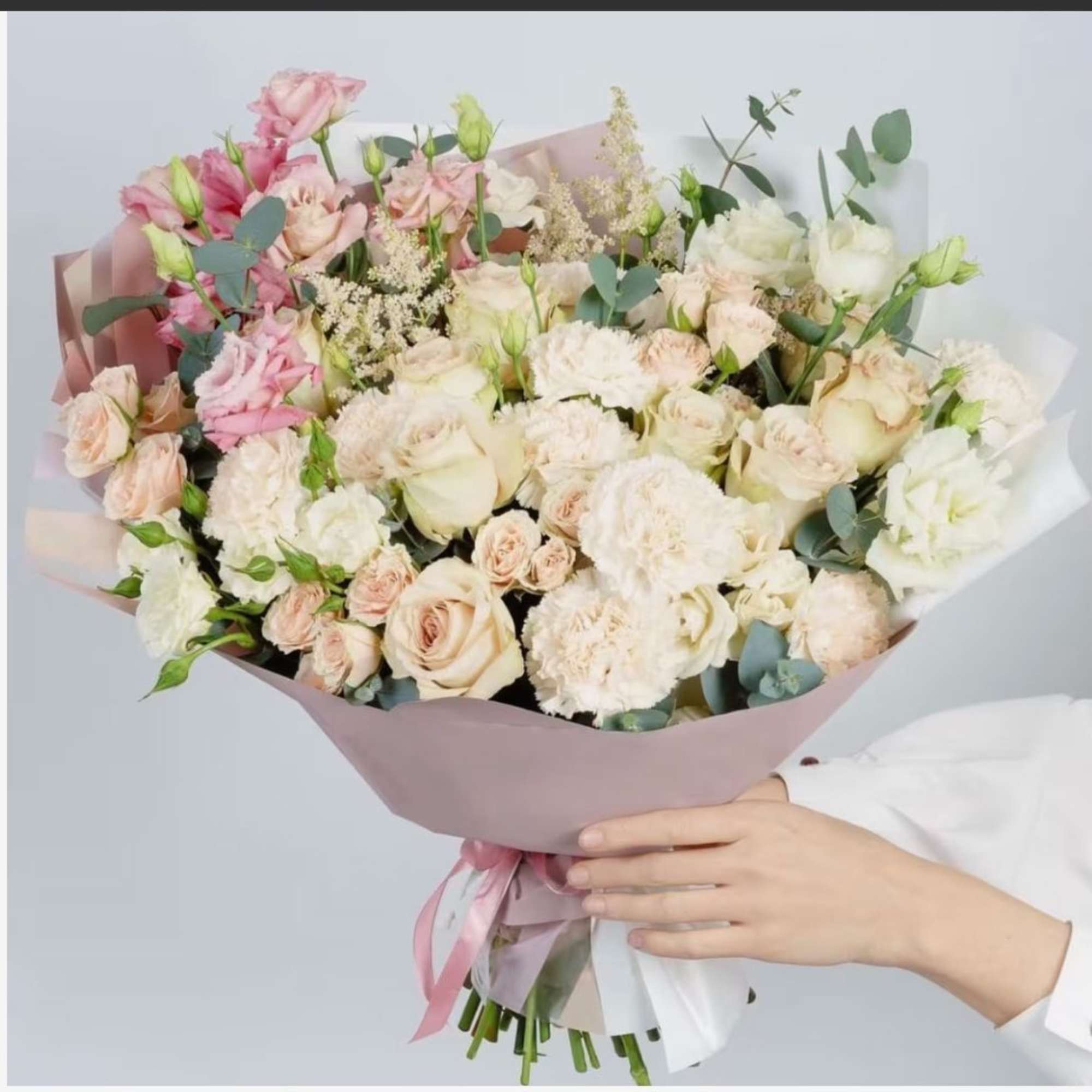 Large bouquet of pale pink and white roses with eucalyptus