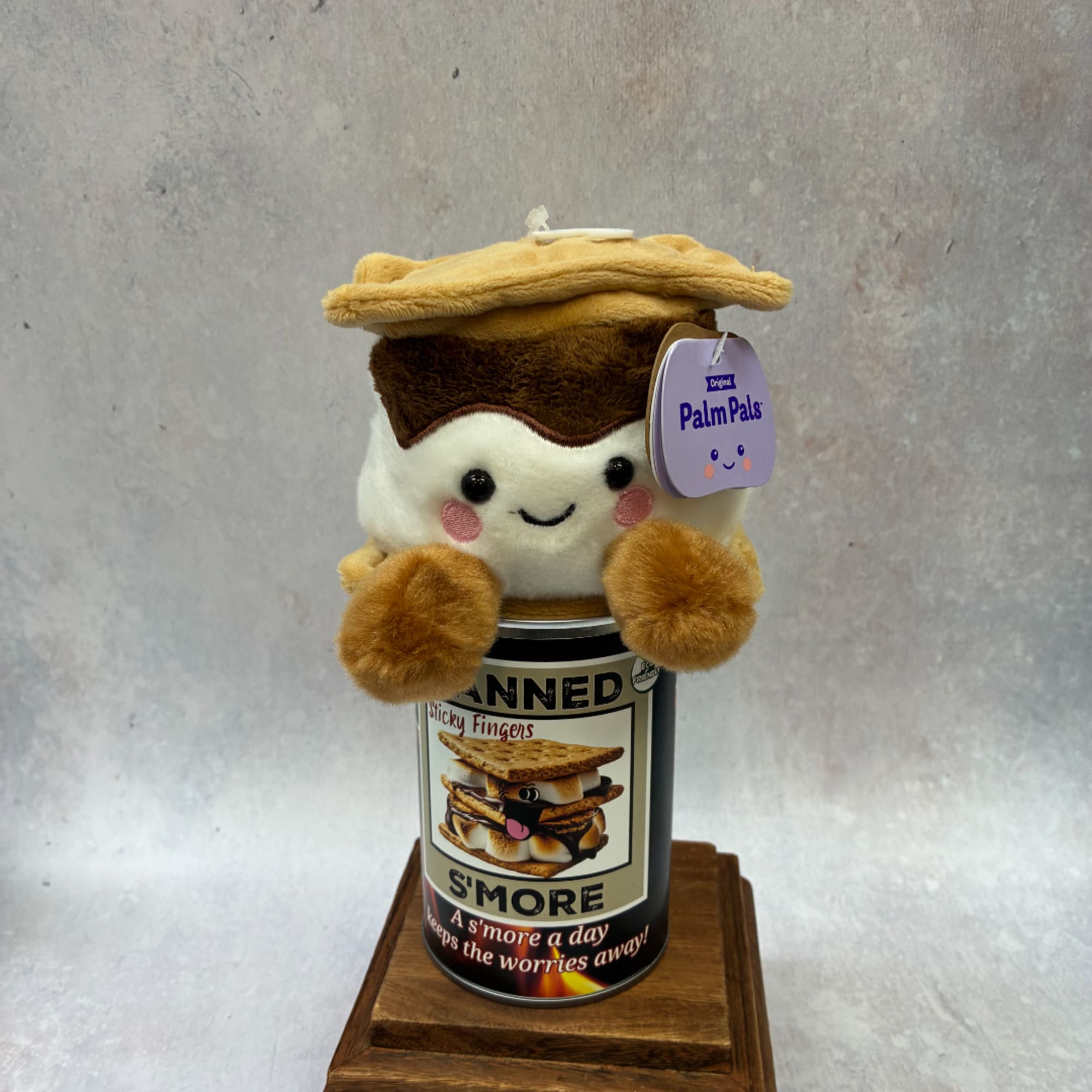 Plush s'more toy sitting on a canned snack container