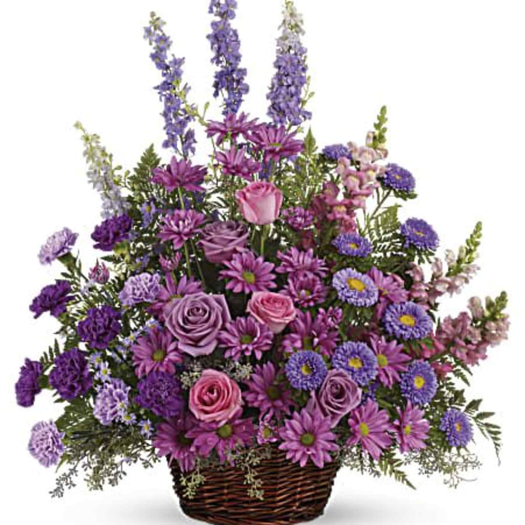 Lavender and purple roses, daisies, and mixed flowers arranged in a wicker basket