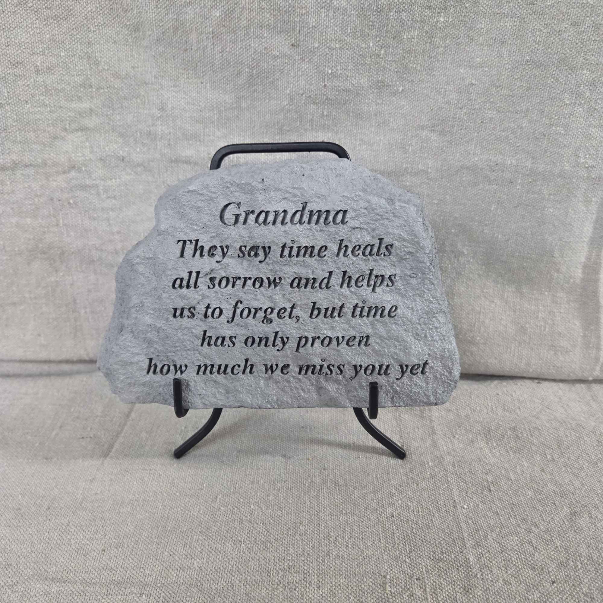 Gray memorial stone for Grandma with engraved verse on a small black stand