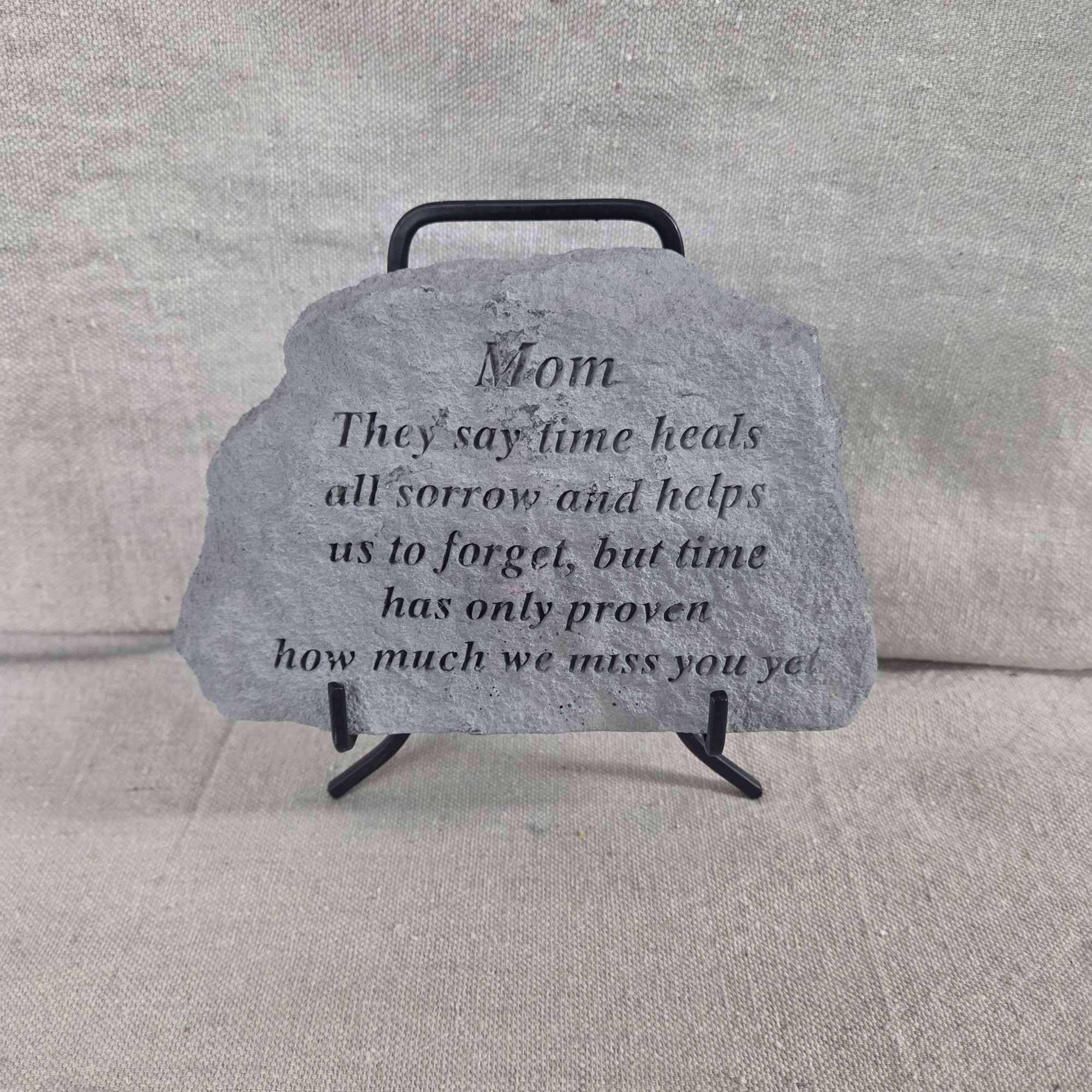 Gray memorial stone for Mom with engraved verse on a small black metal stand.