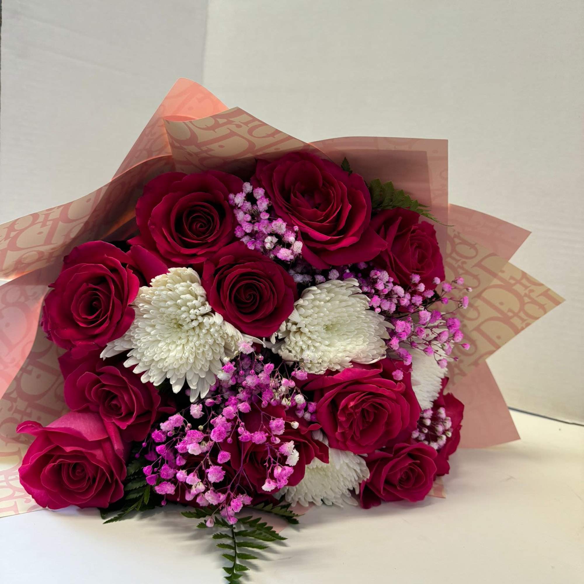 Bouquet of red roses, white chrysanthemums, and pink baby's breath