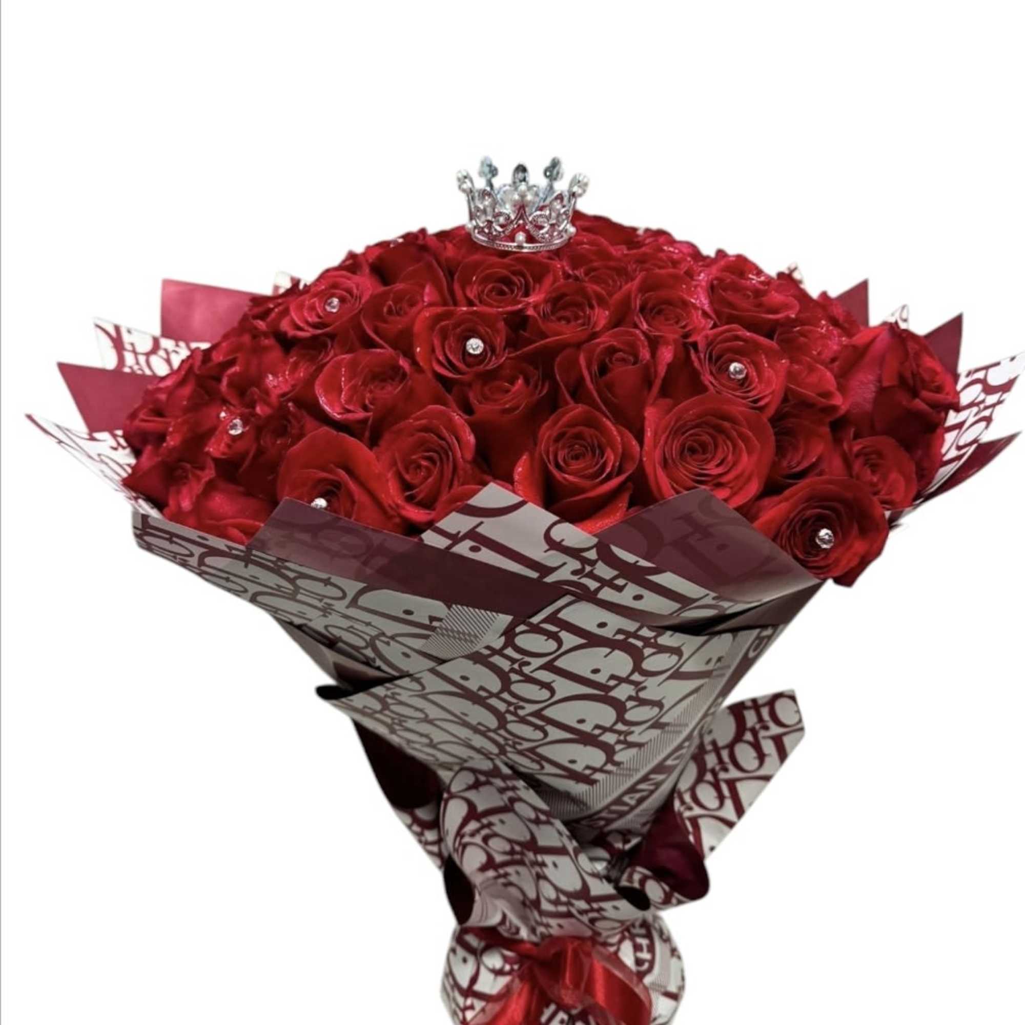 Bouquet of red roses with a small crown topper
