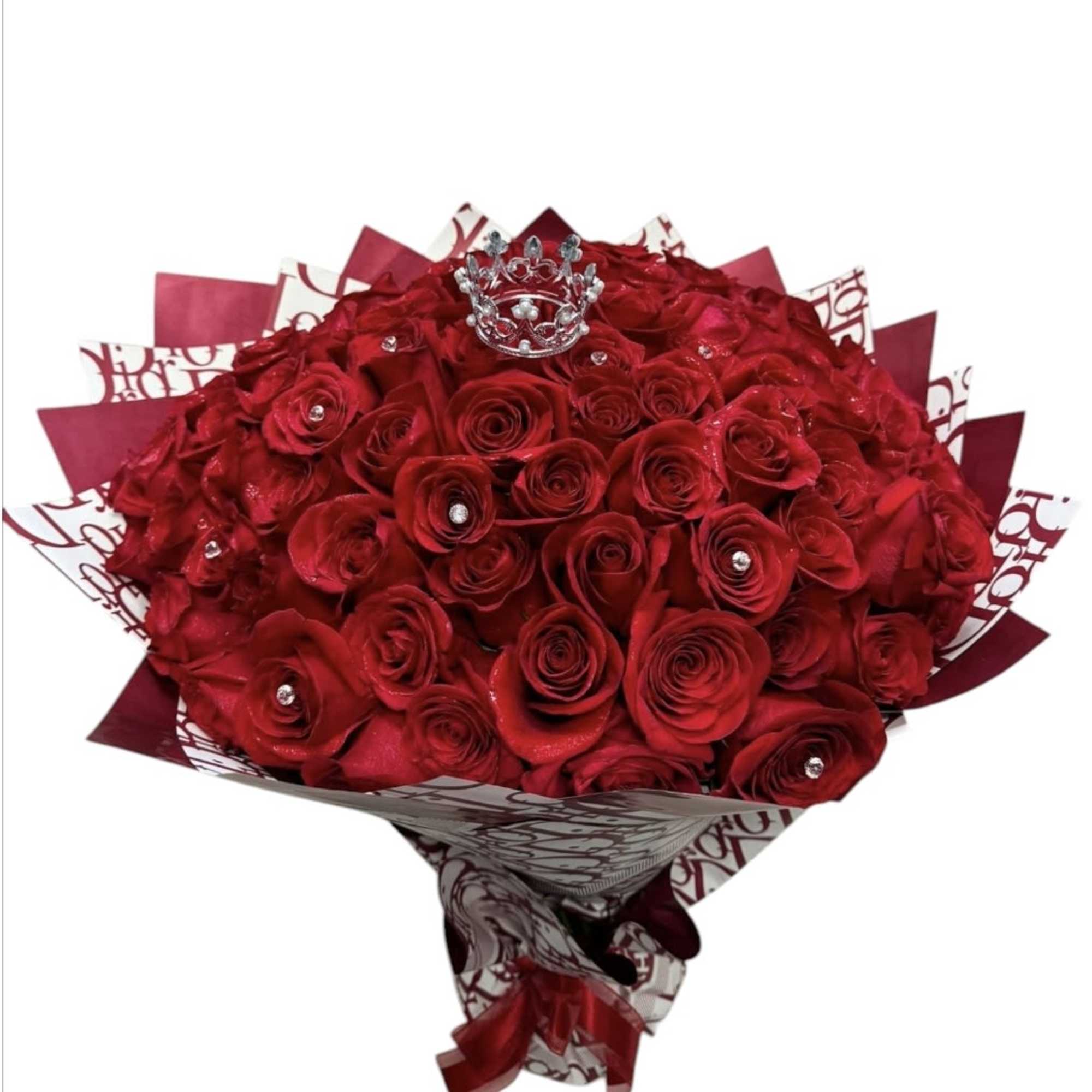 Bouquet of red roses with a small crown topper and patterned wrap