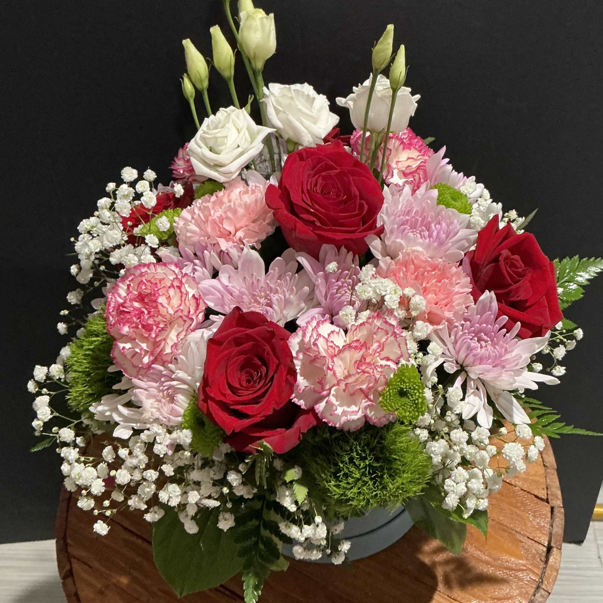 Bouquet of red and white roses with pink carnations and daisies