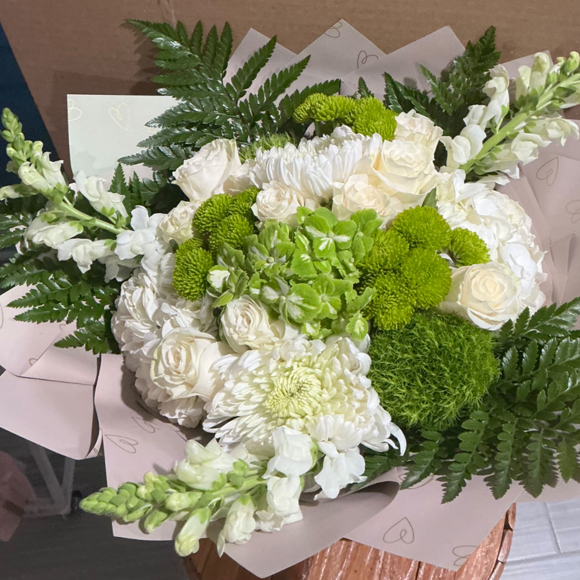 White and green bouquet with roses, chrysanthemums, and snapdragons