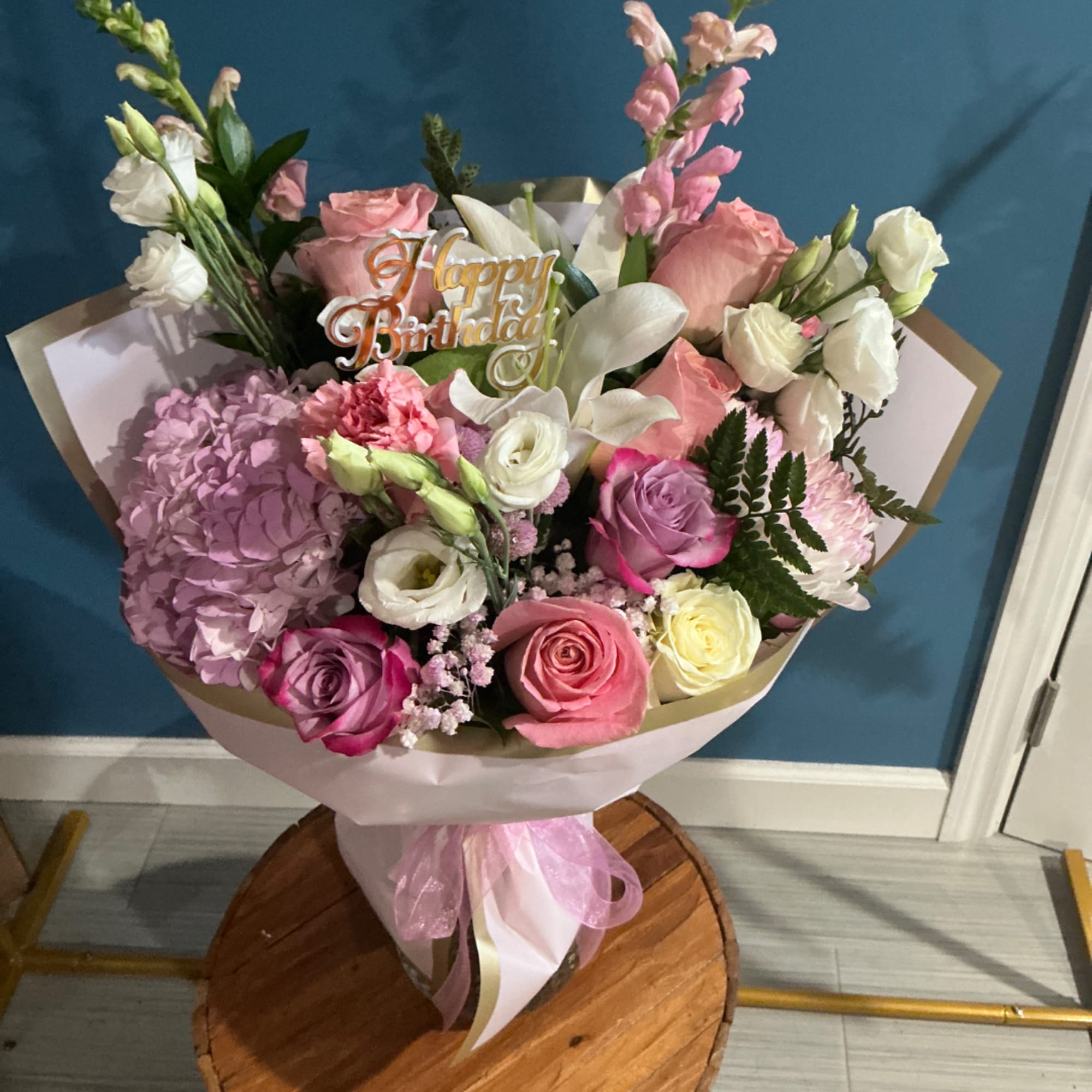 Pink and white mixed flower bouquet with a birthday topper