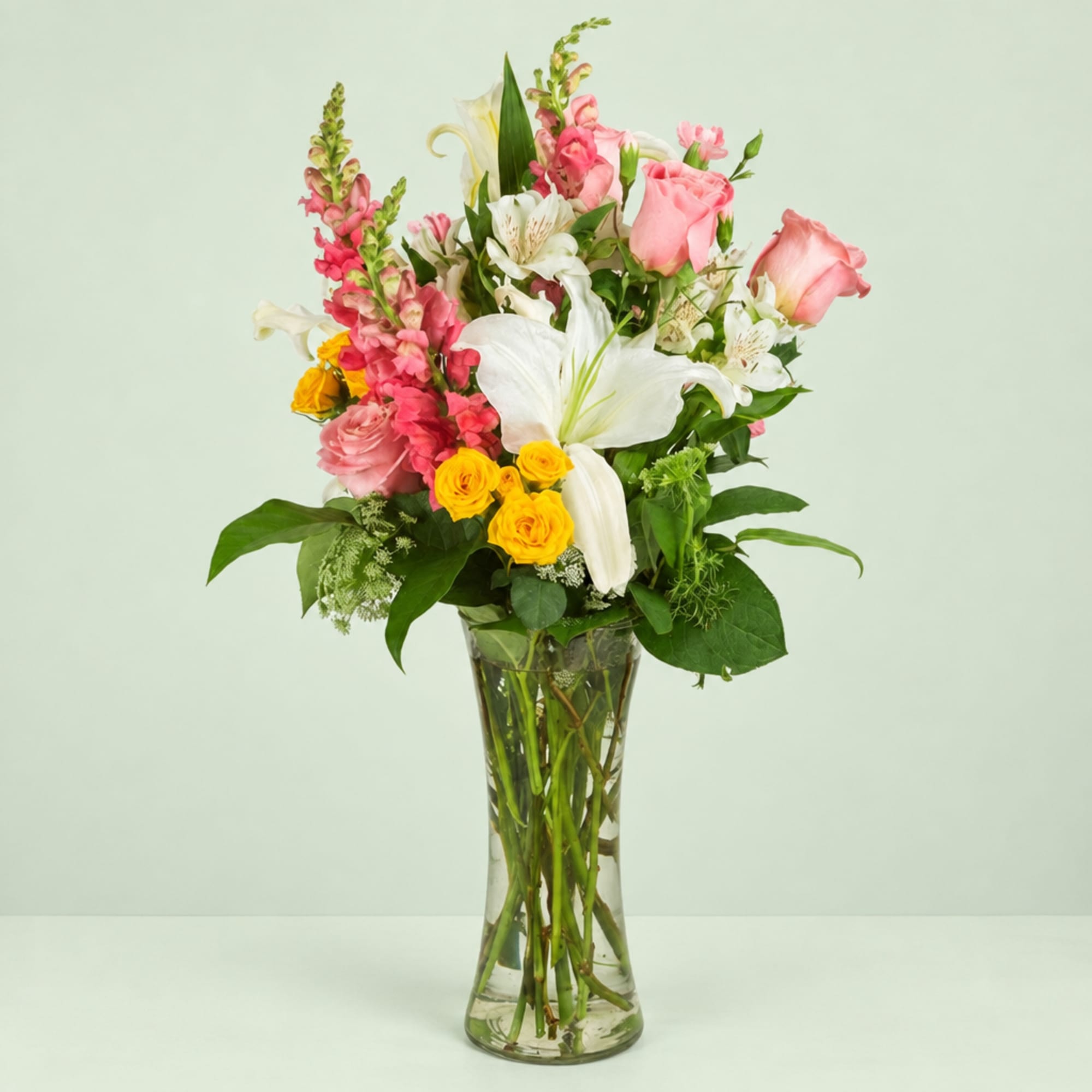Pink and white mixed bouquet in a clear glass vase