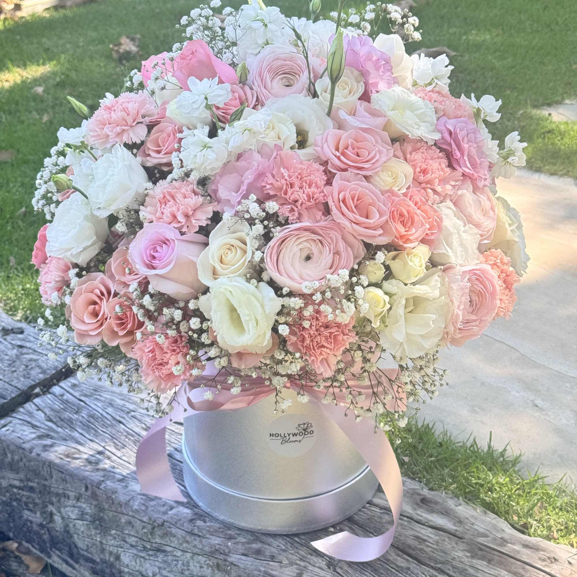 Pink and white bouquet in a silver hatbox with ribbon