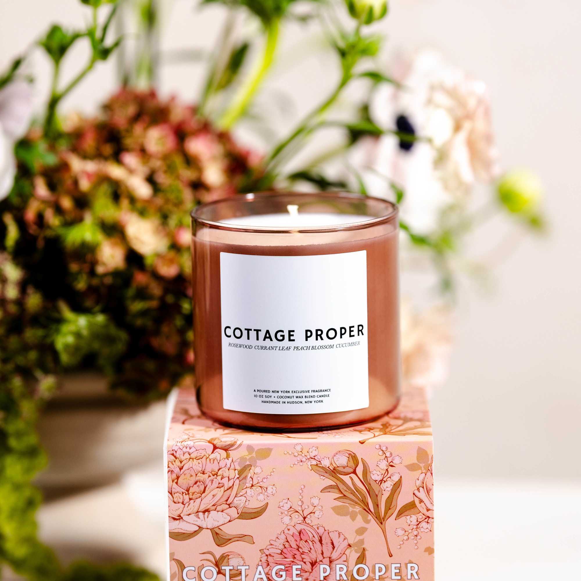 Brown glass candle on a floral-patterned box