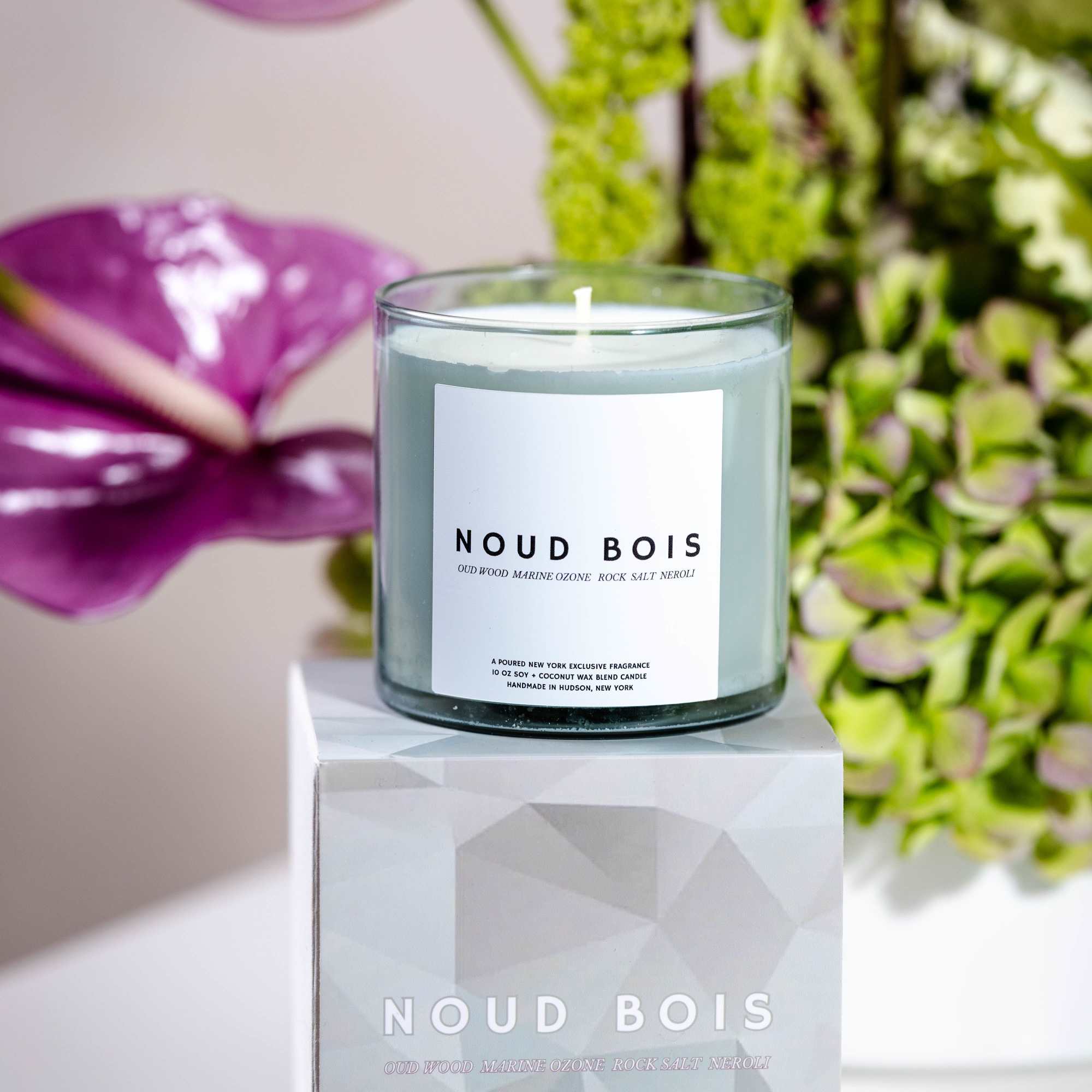 Scented candle in a glass jar on a matching box