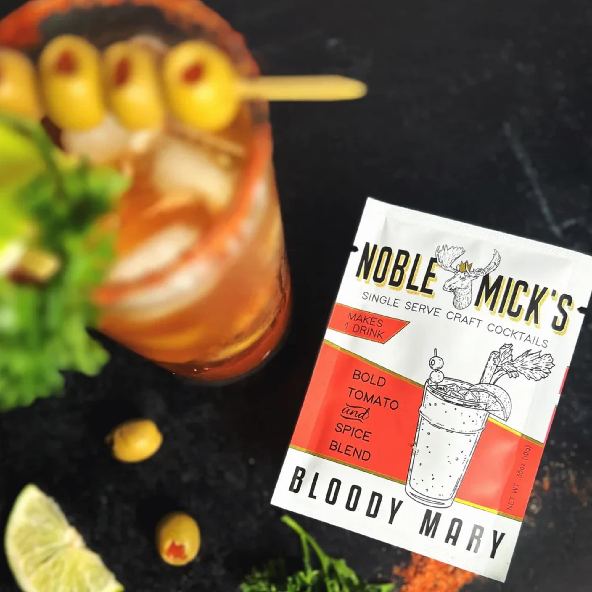 Bloody Mary cocktail mix packet beside a garnished drink