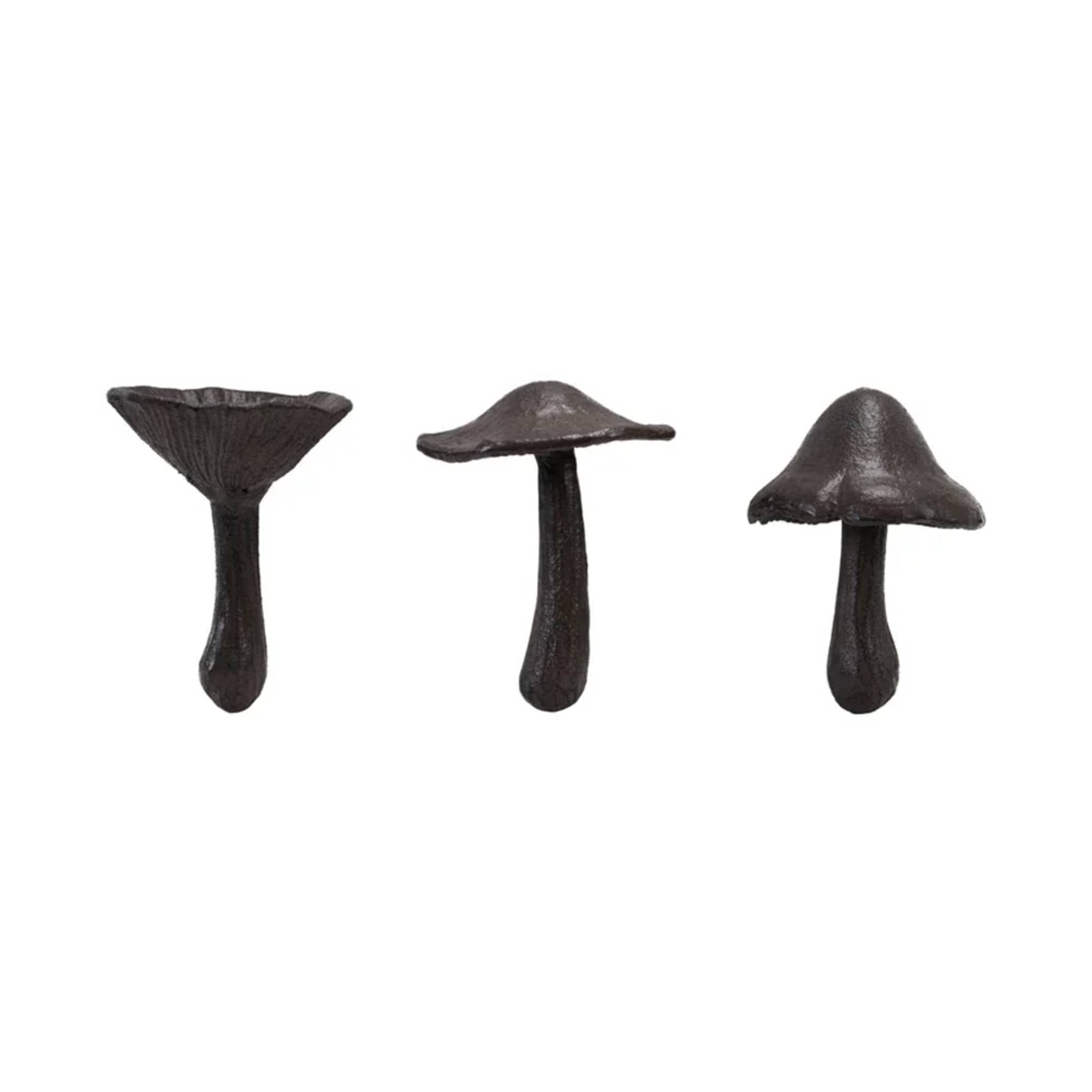 Three dark mushroom-shaped decorative objects on a white background