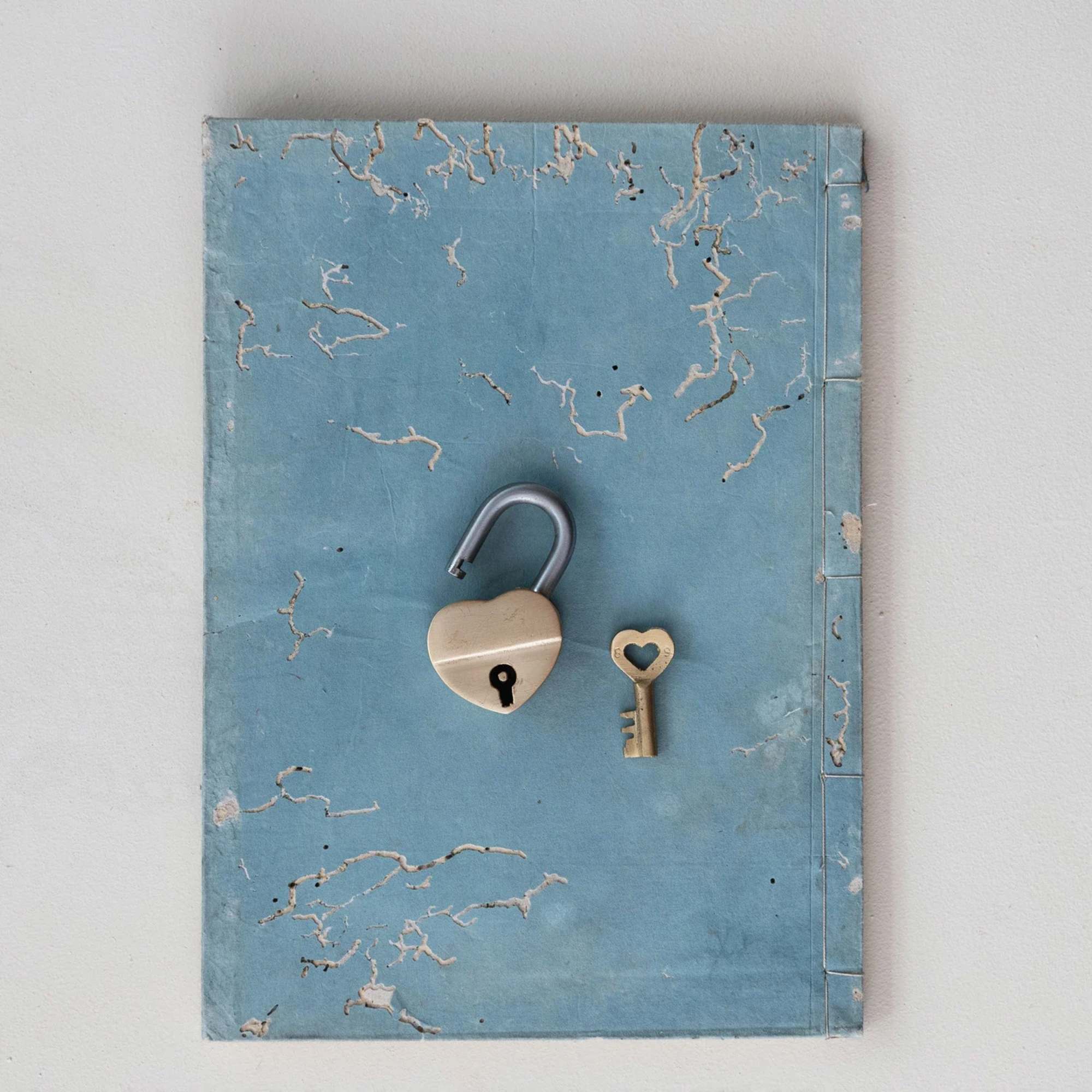 Blue book cover with a heart-shaped padlock and small key