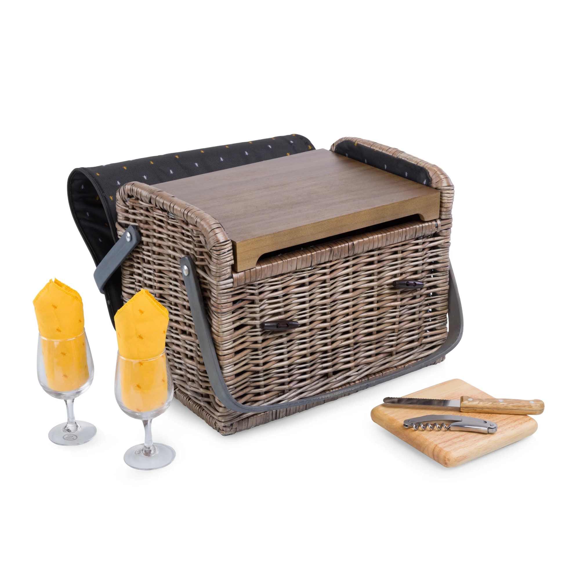 Picnic basket with two filled wine glasses and a cutting board with knife and corkscrew