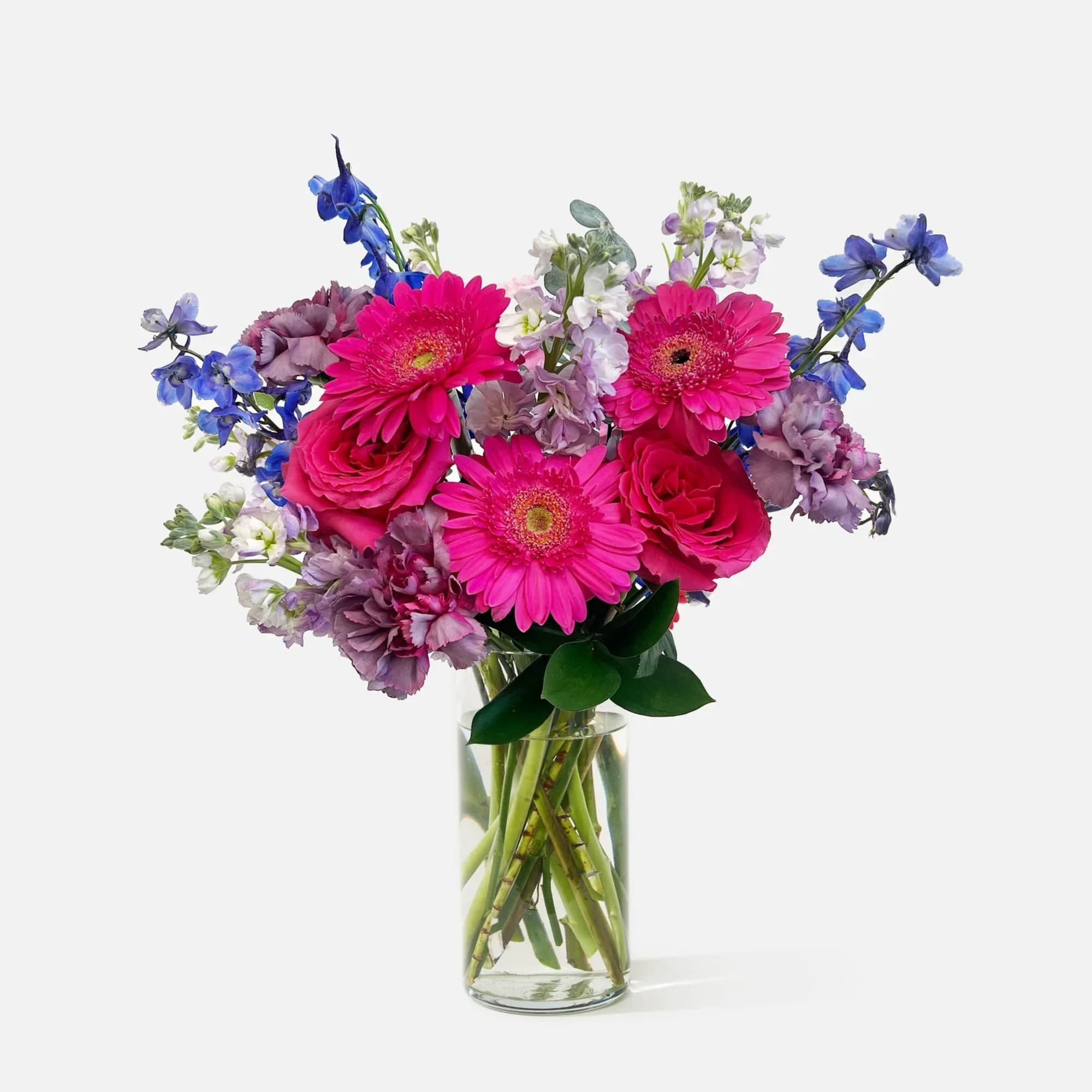 Bouquet of pink and purple flowers in a clear glass vase