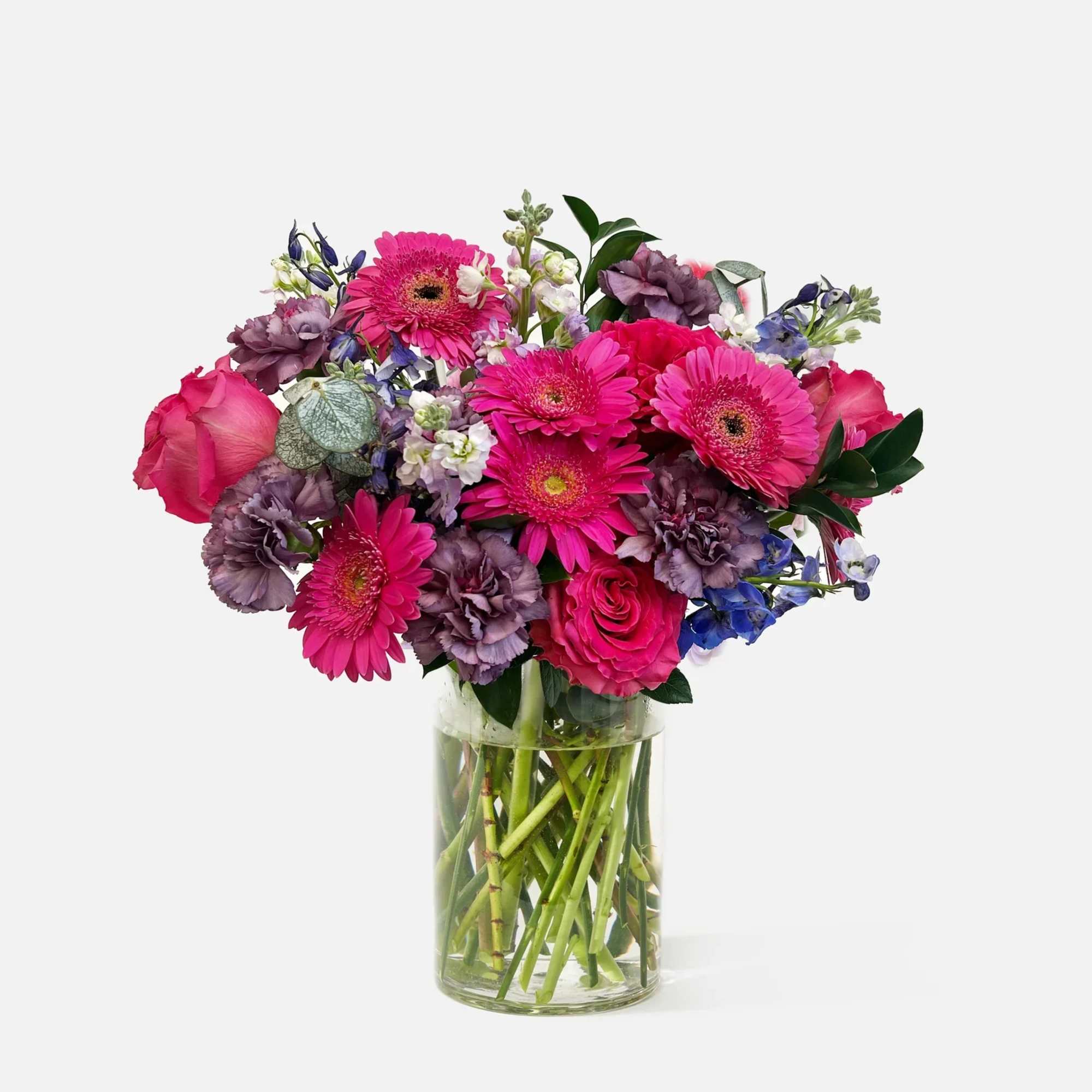 Pink and purple mixed bouquet in a clear glass vase