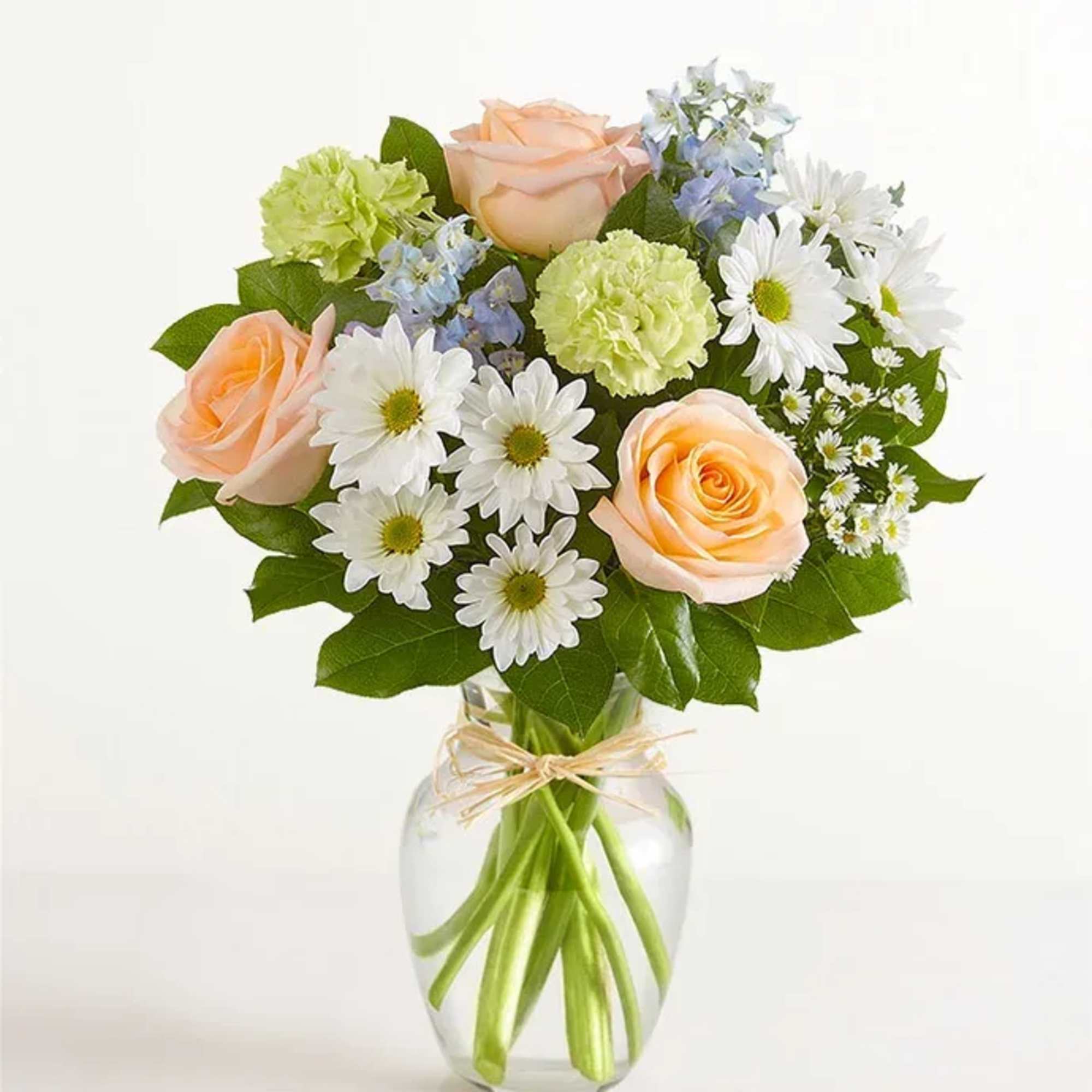 All-around arrangement with peach roses, blue delphiniums, lime-green carnations, and white daisy